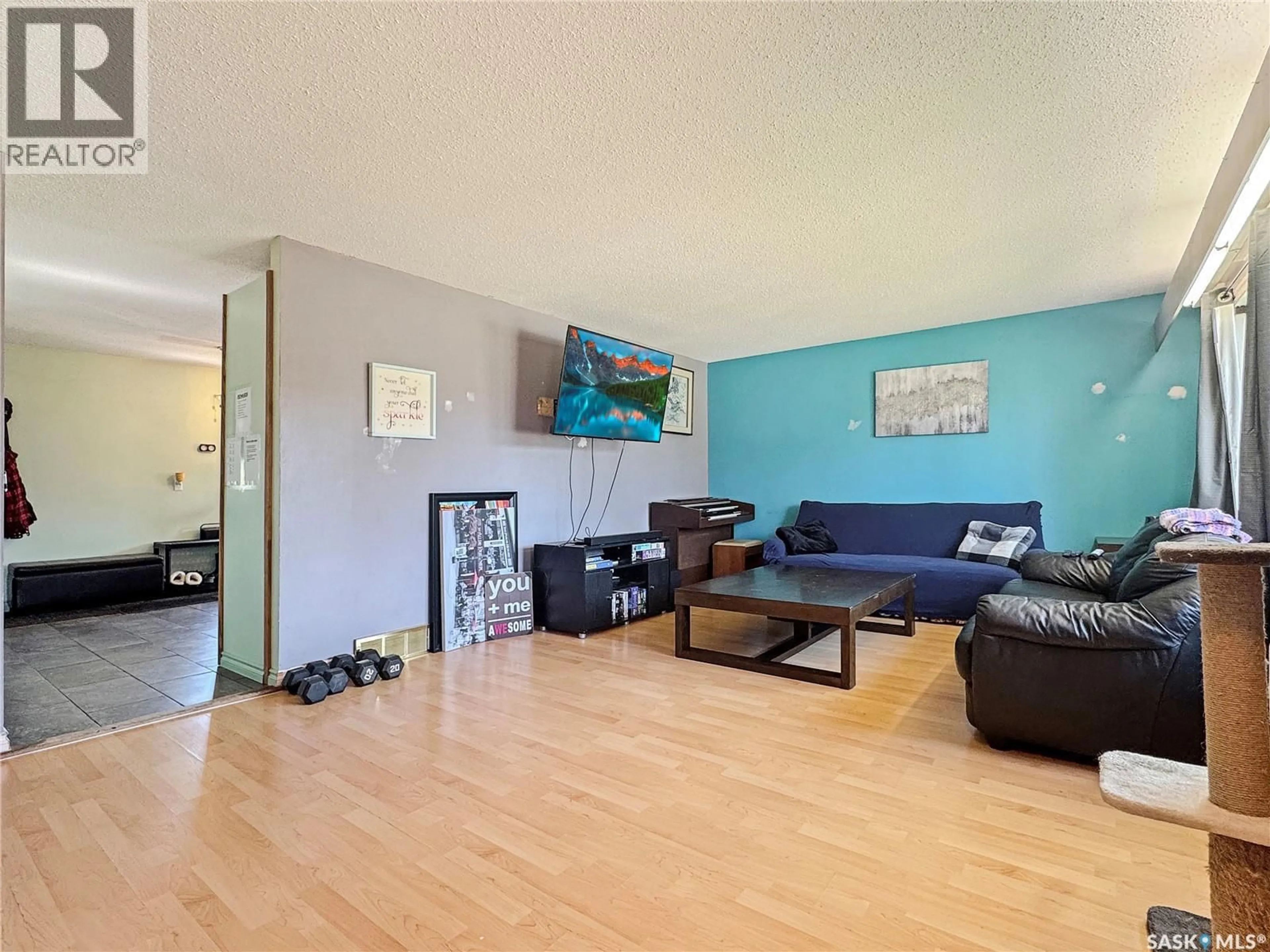 Living room with furniture, wood/laminate floor for 106 STRANGE STREET, Cut Knife Saskatchewan S0M0N0