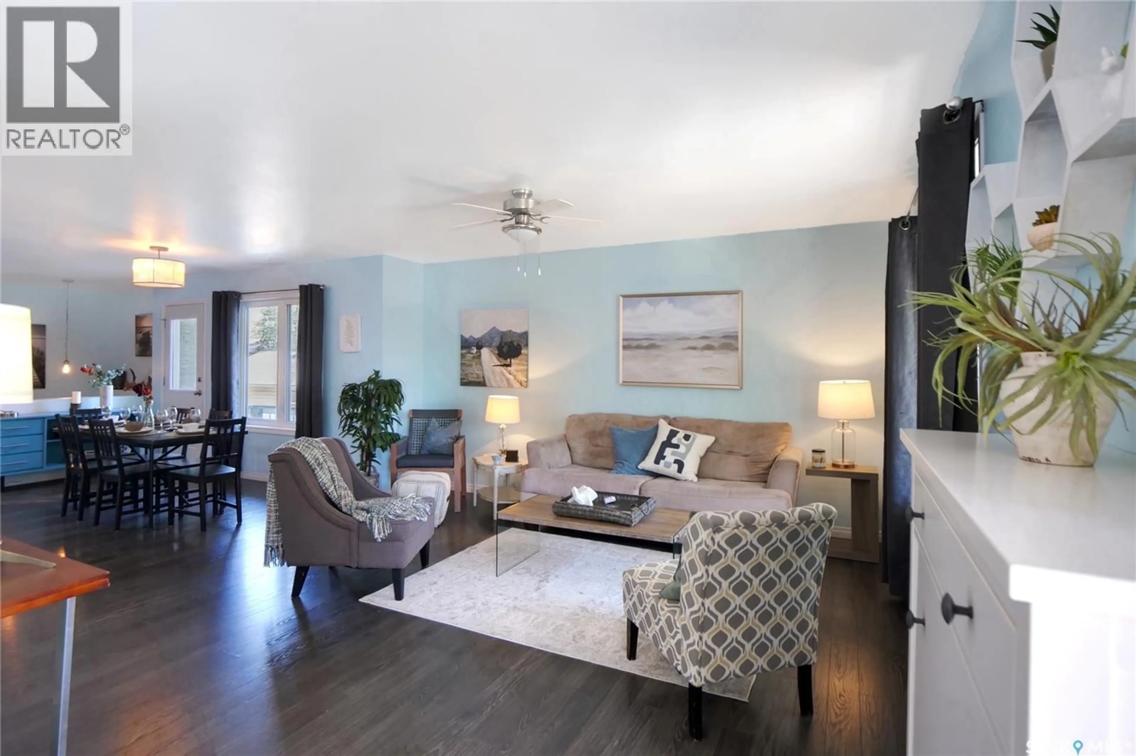 Living room with furniture, wood/laminate floor for 908 STADACONA STREET, Moose Jaw Saskatchewan S6H0K8