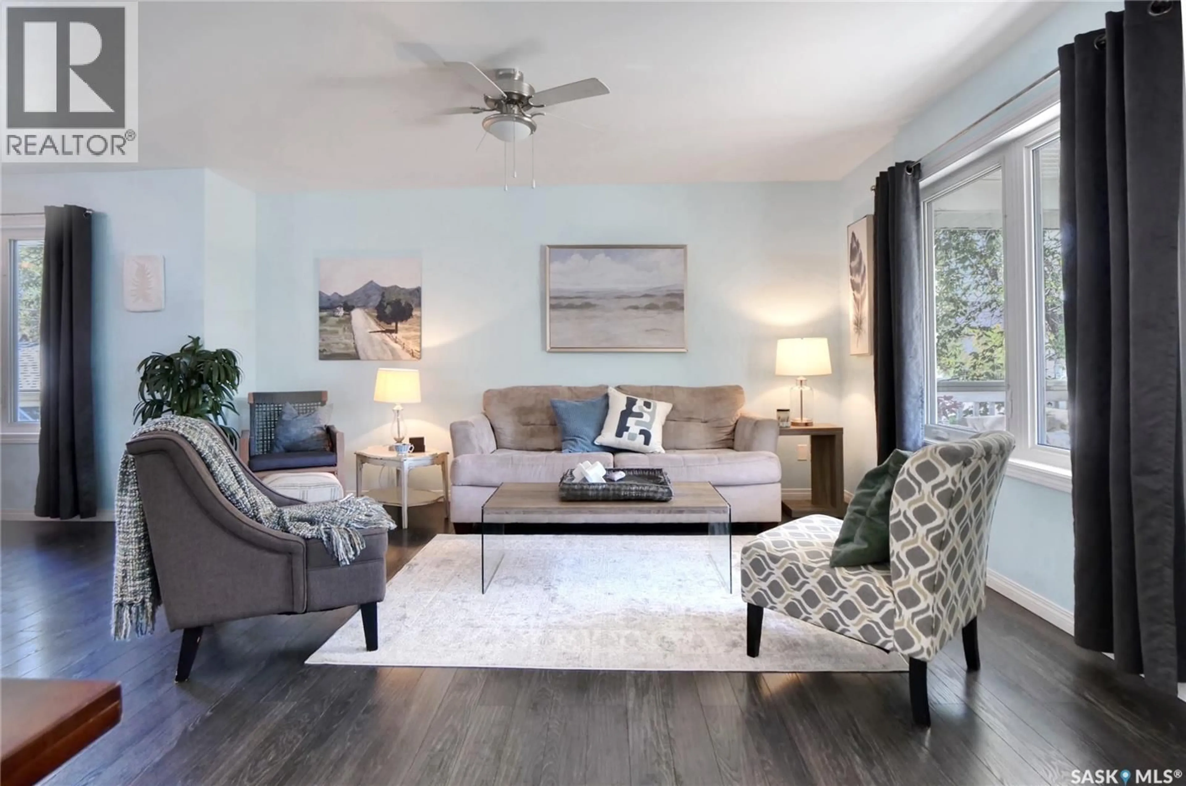 Living room with furniture, wood/laminate floor for 908 STADACONA STREET, Moose Jaw Saskatchewan S6H0K8
