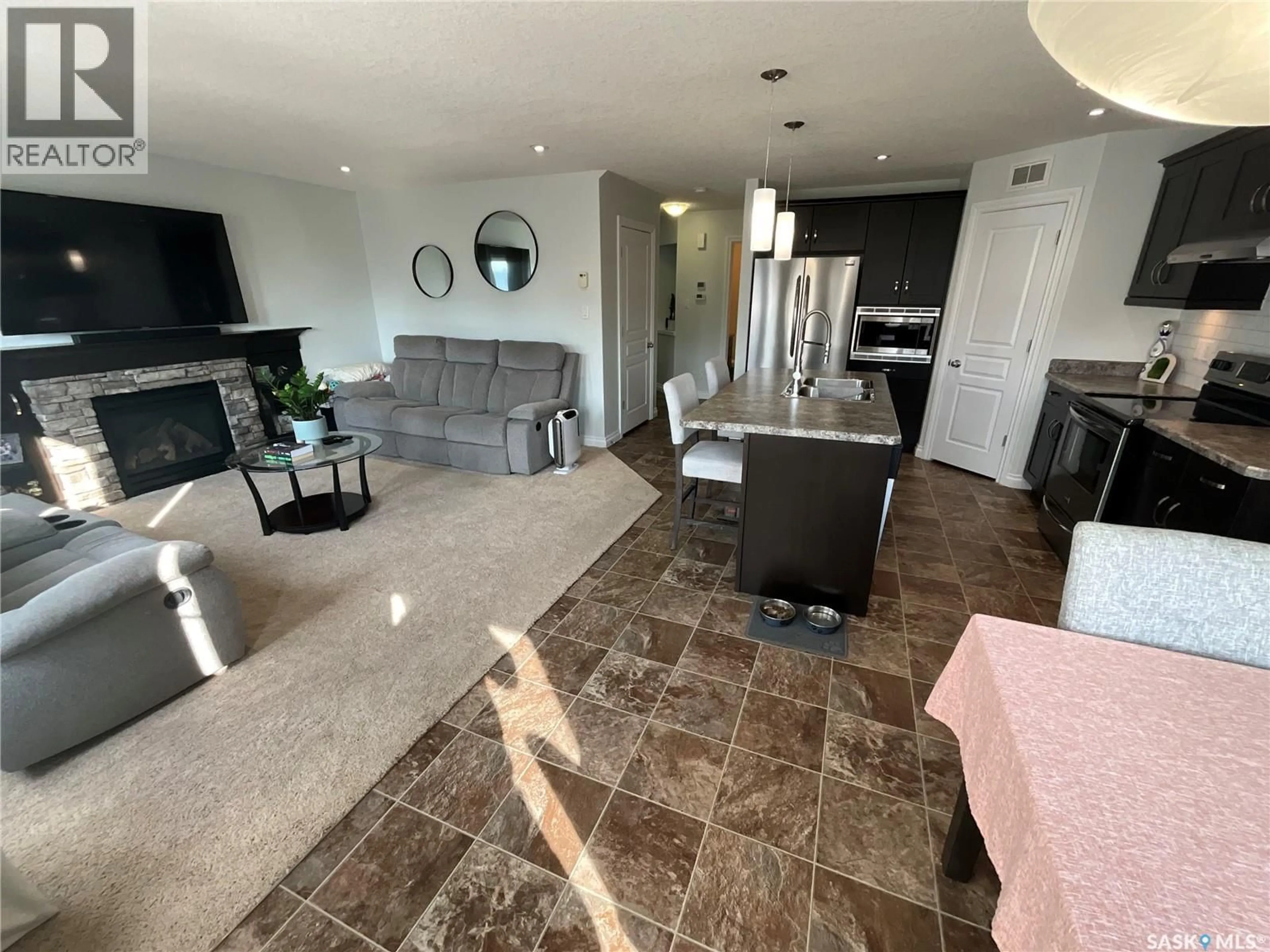 Living room with furniture, ceramic/tile floor for 8709 HINCKS LANE, Regina Saskatchewan S4Y0B9