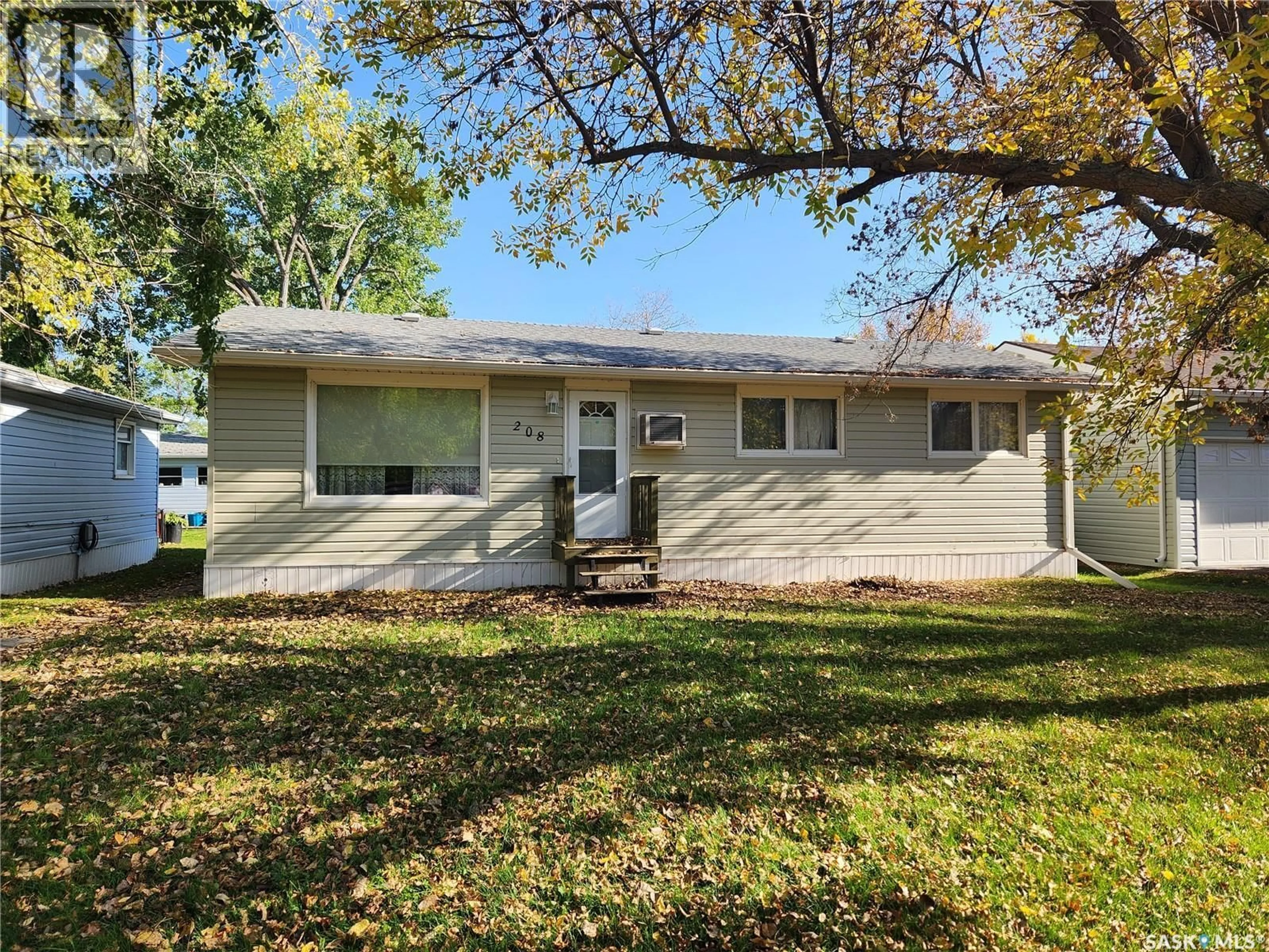 Home with vinyl exterior material, street for 208 2ND AVENUE, Lampman Saskatchewan S0C1N0