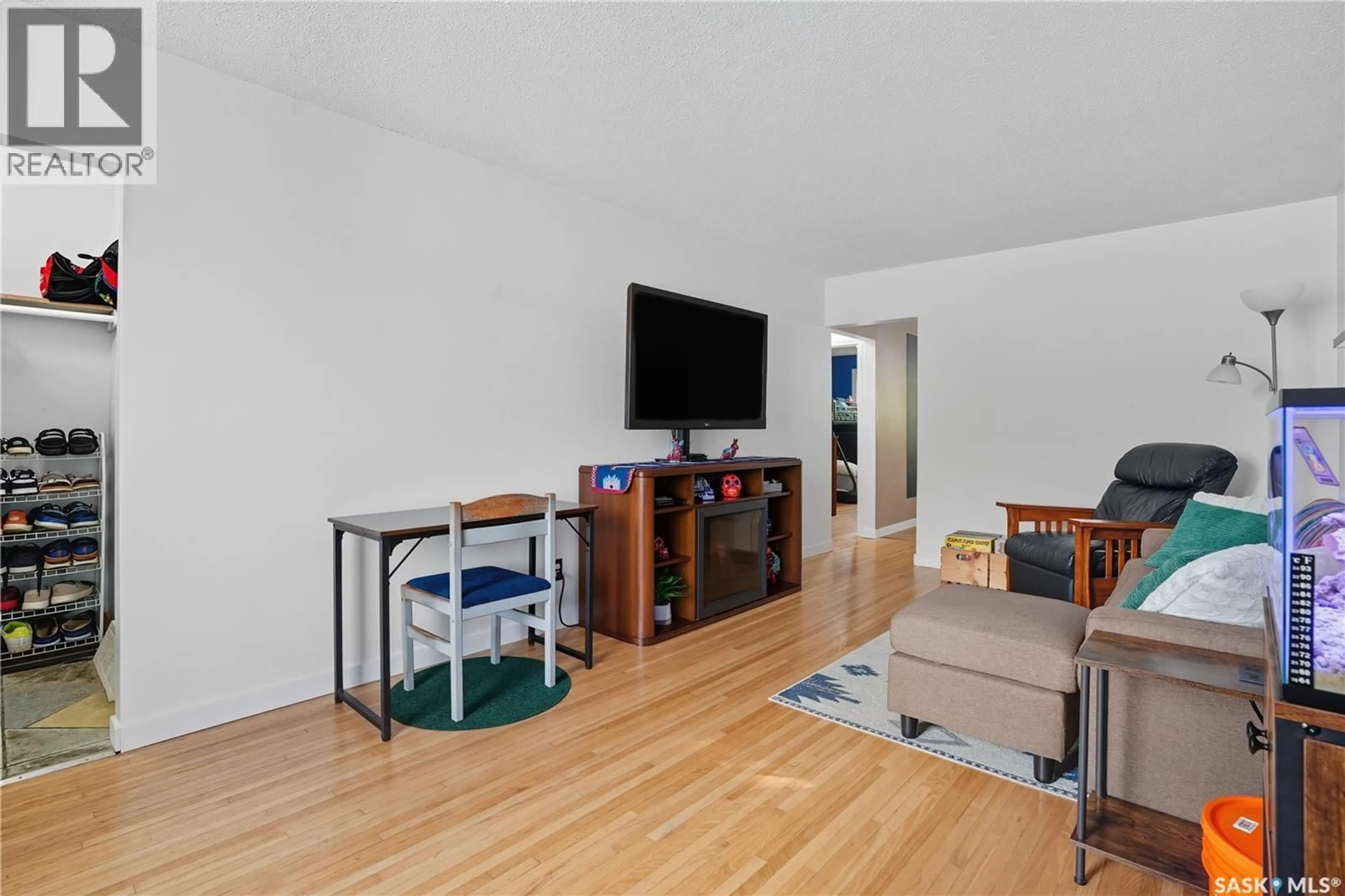 Living room with furniture, wood/laminate floor for 658 GARNET STREET, Regina Saskatchewan S4T2W8