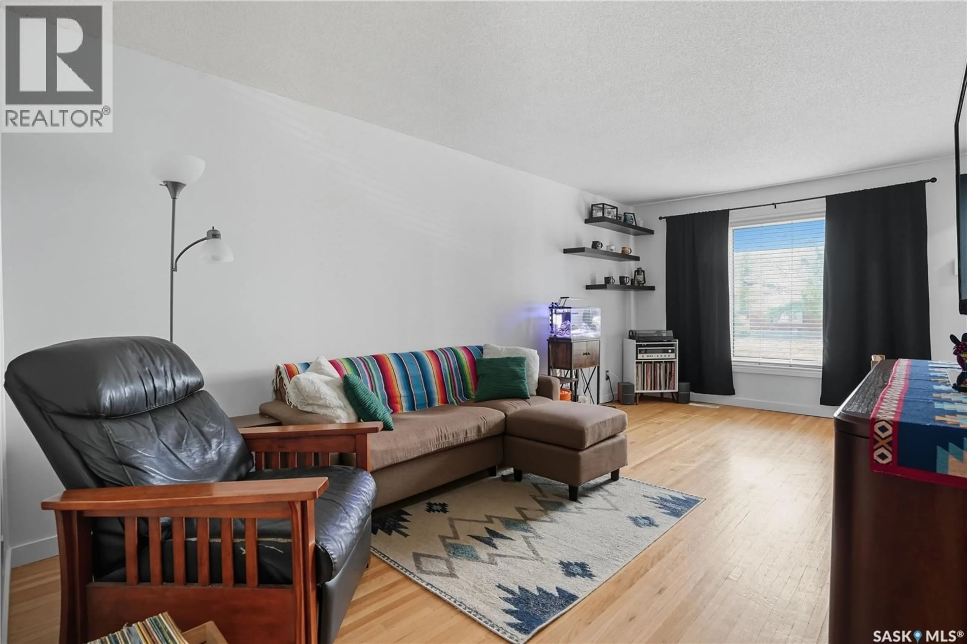 Living room with furniture, wood/laminate floor for 658 GARNET STREET, Regina Saskatchewan S4T2W8