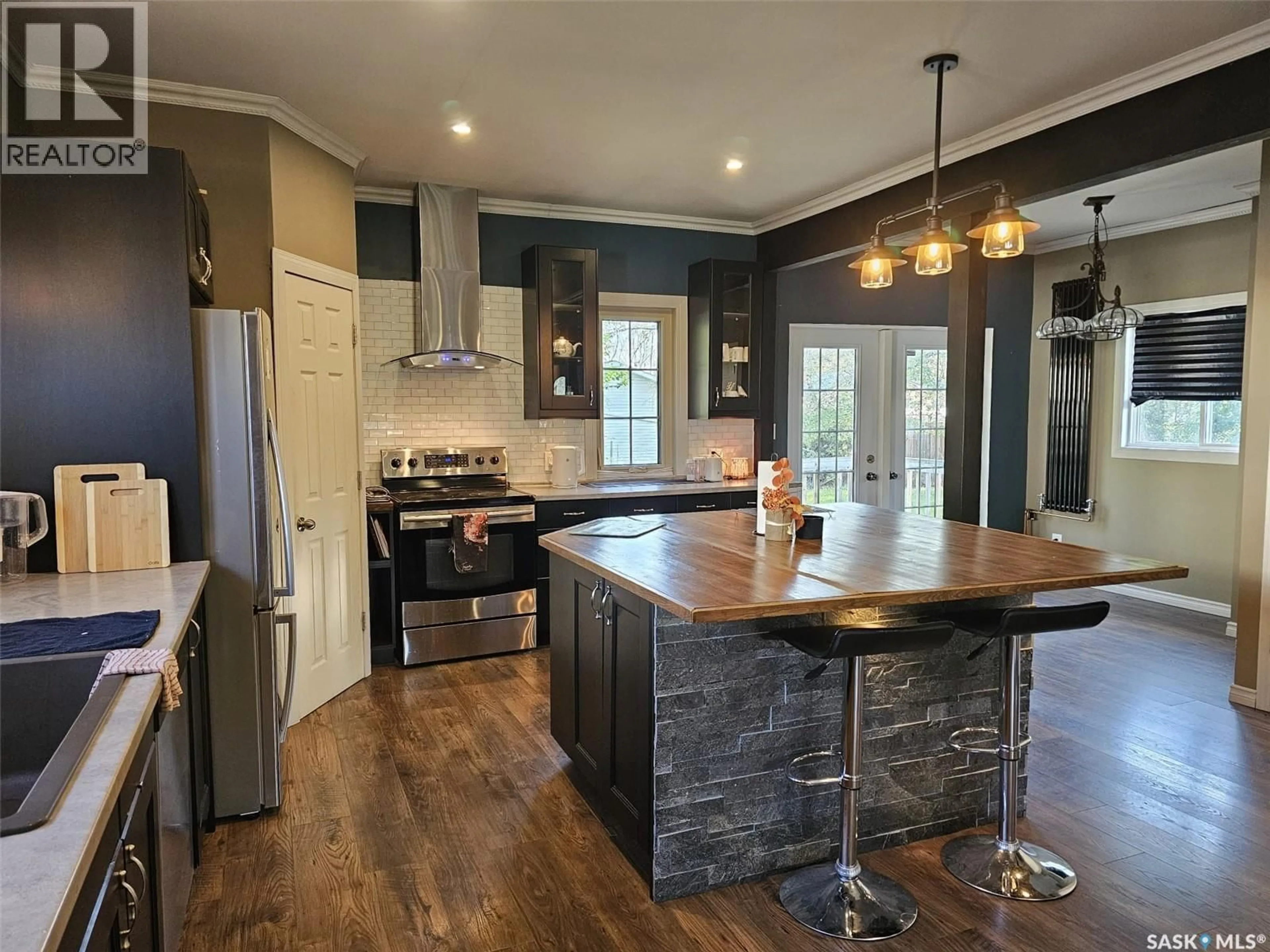 Open concept kitchen, wood/laminate floor for 608 WALSH AVENUE, Oxbow Saskatchewan S0C2B0