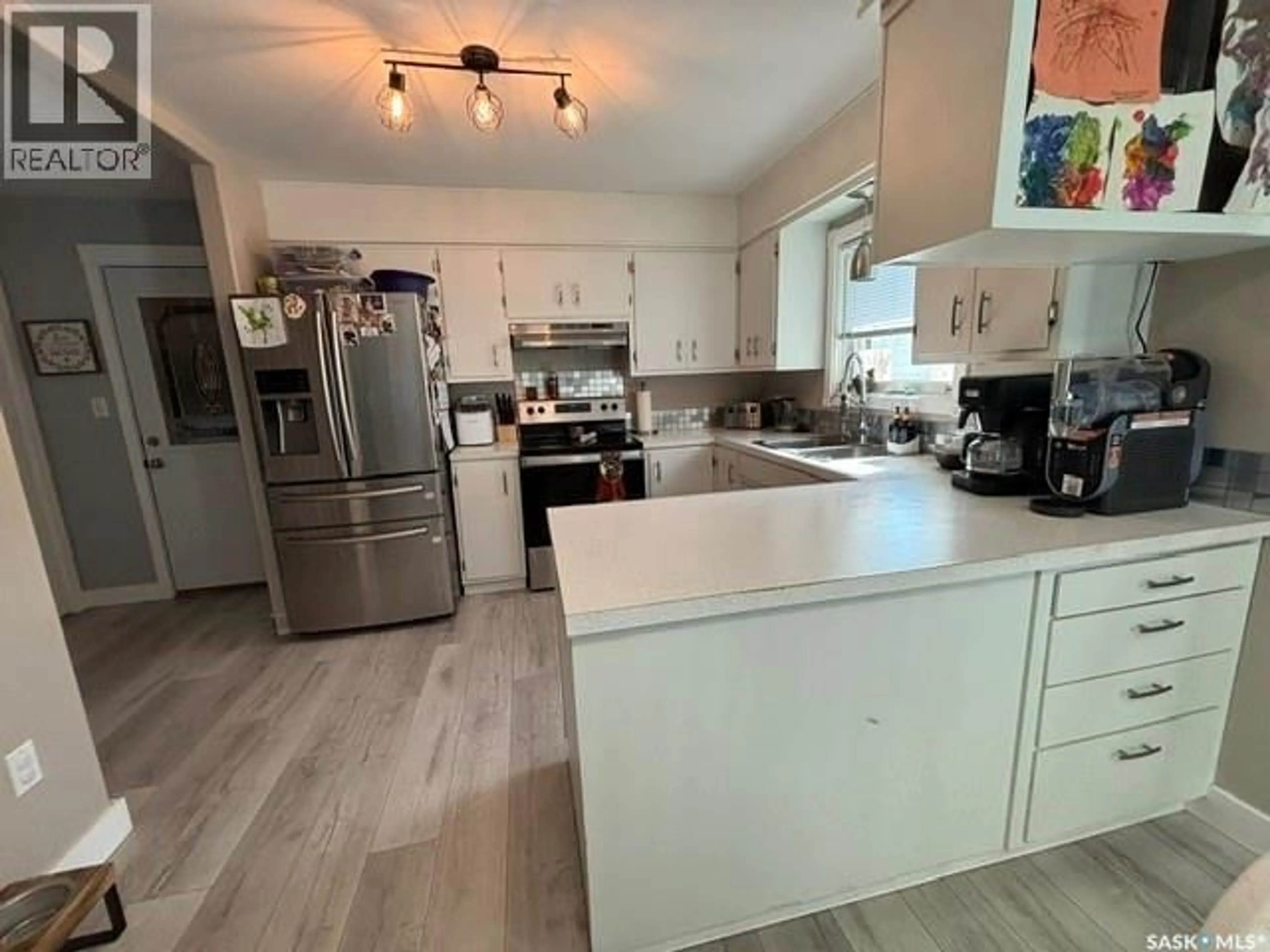 Open concept kitchen, wood/laminate floor for 856 WALSH AVENUE, Oxbow Saskatchewan S0C2B0