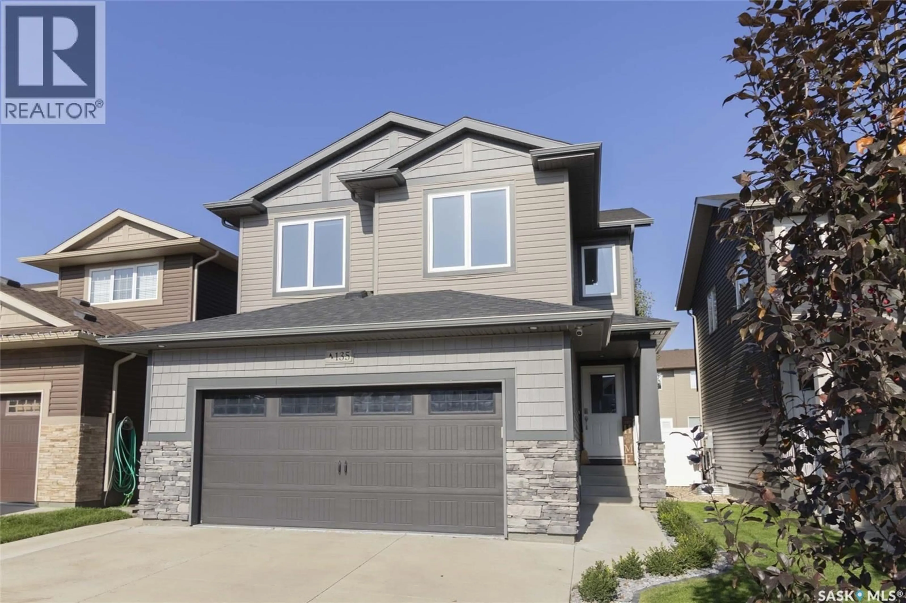 Home with vinyl exterior material, street for 135 DAGNONE LANE, Saskatoon Saskatchewan S7V0P6