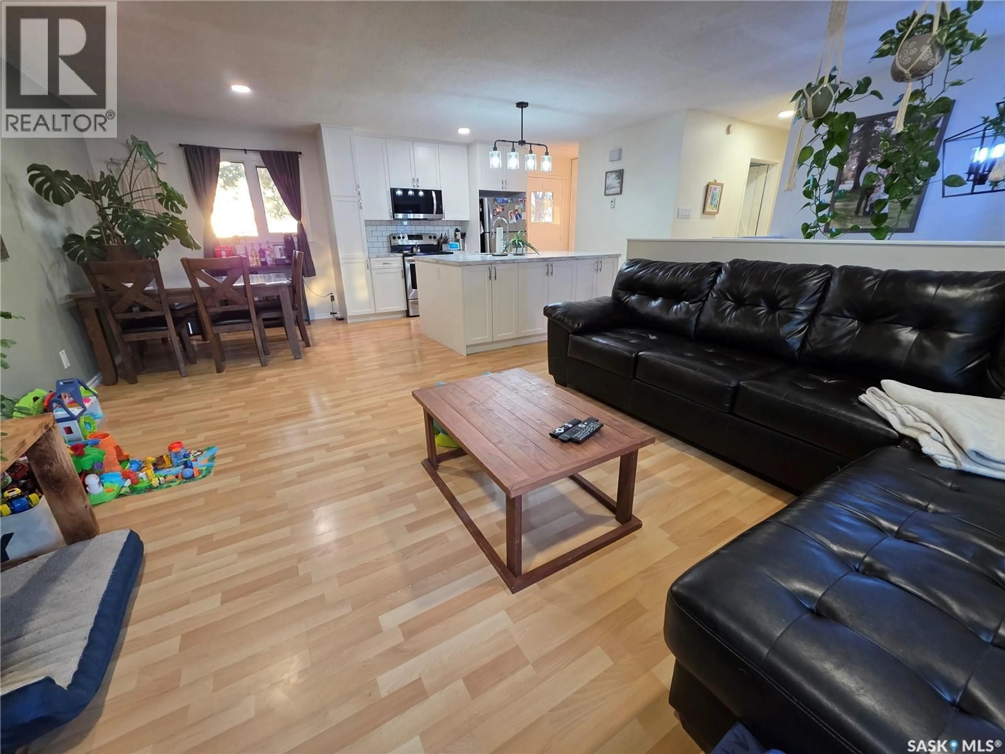 Living room with furniture, wood/laminate floor for 142 1ST AVENUE, Swift Current Saskatchewan S9H3H2