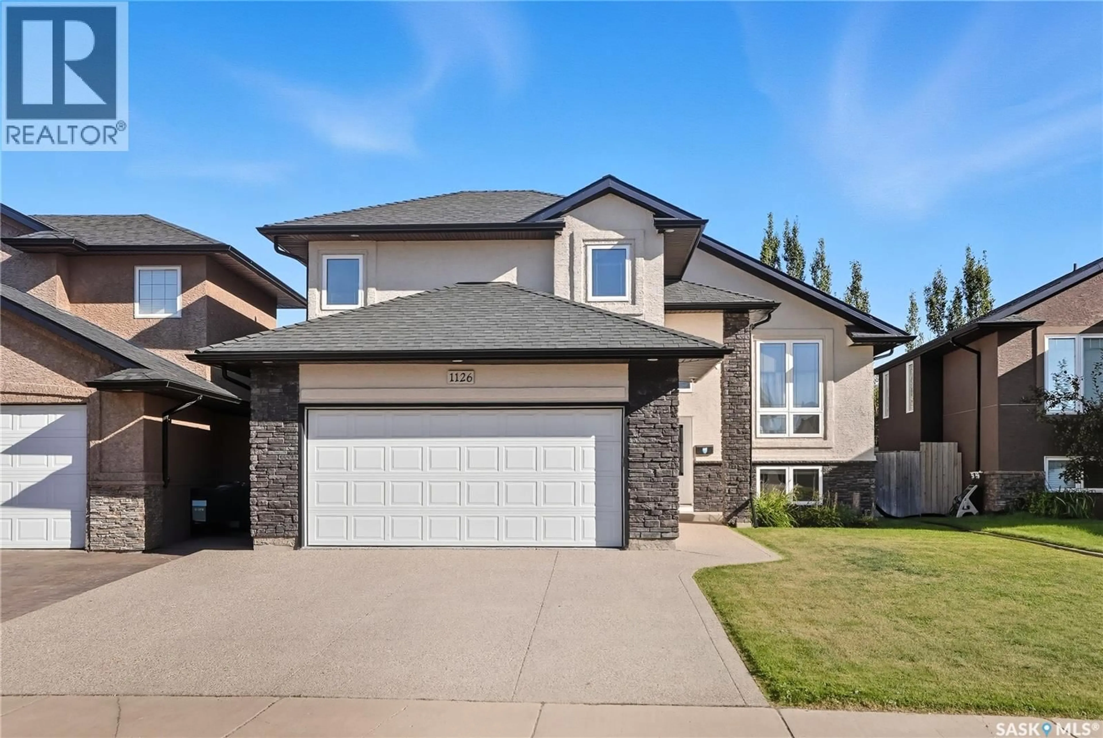 Home with vinyl exterior material, street for 1126 STENSRUD ROAD, Saskatoon Saskatchewan S7W0B5