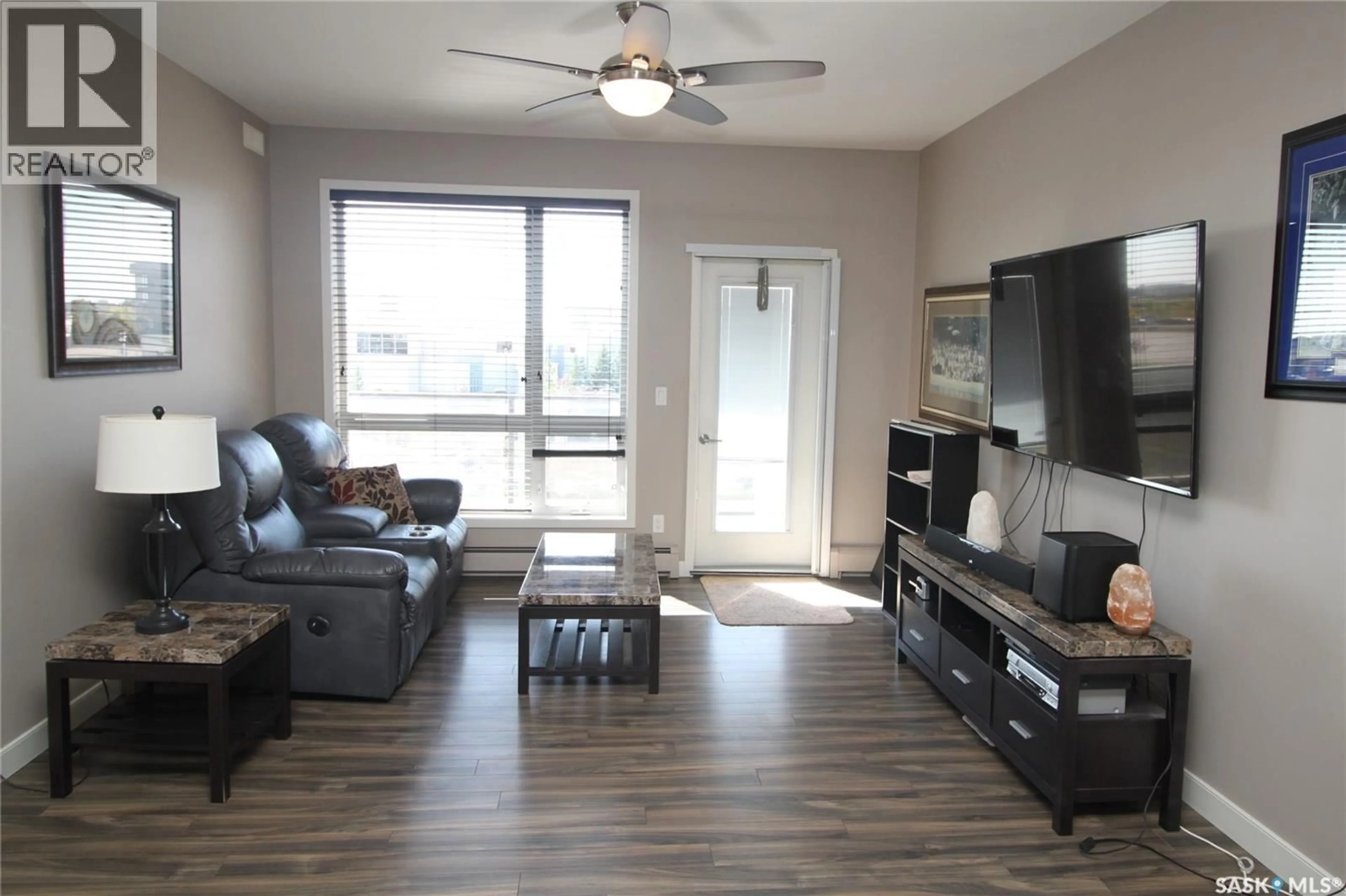 Living room with furniture, wood/laminate floor for 221 158 PAWLYCHENKO LANE, Saskatoon Saskatchewan S7V0C3