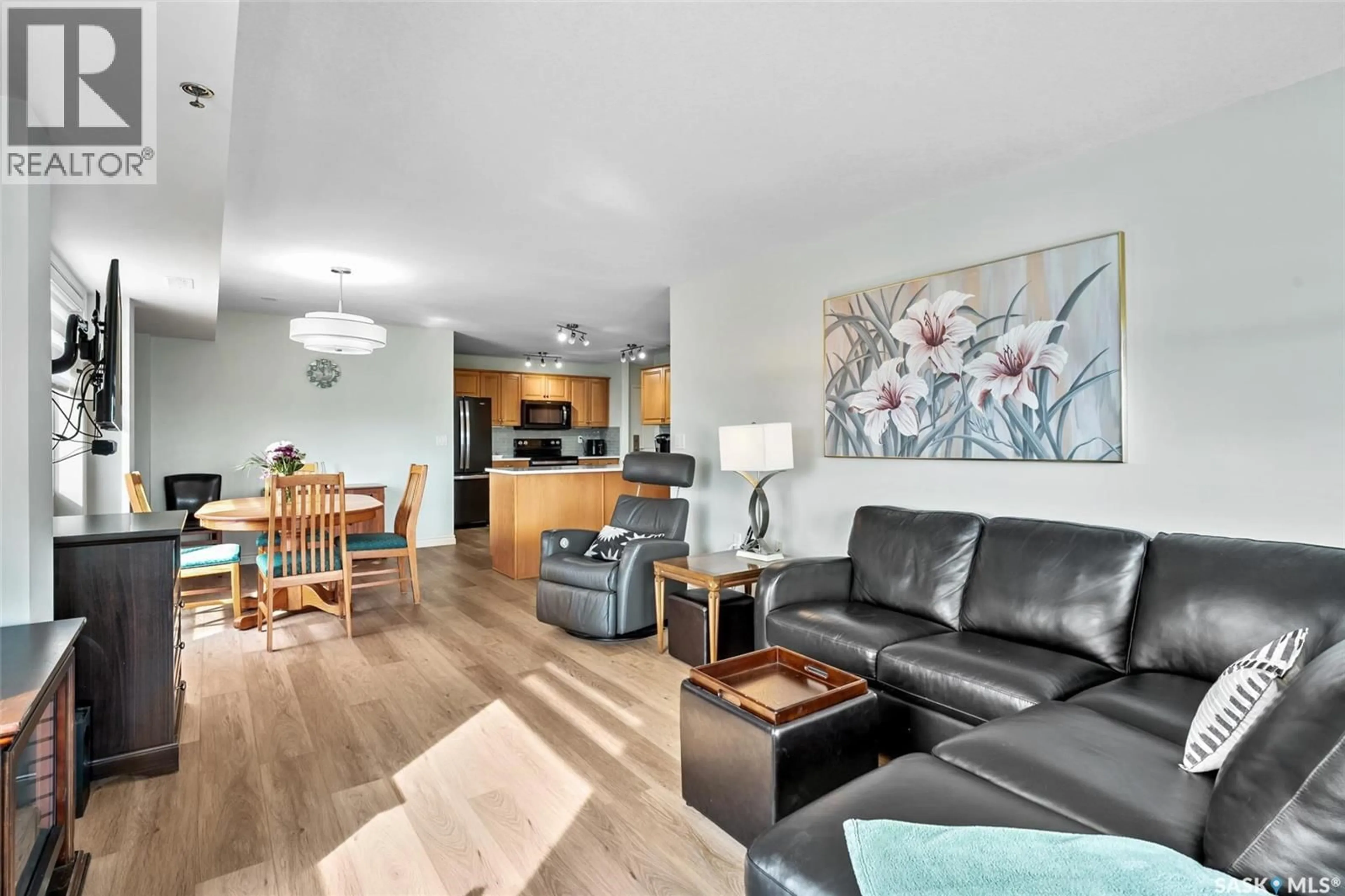 Living room with furniture, wood/laminate floor for 802 2221 ADELAIDE STREET, Saskatoon Saskatchewan S7J5L9