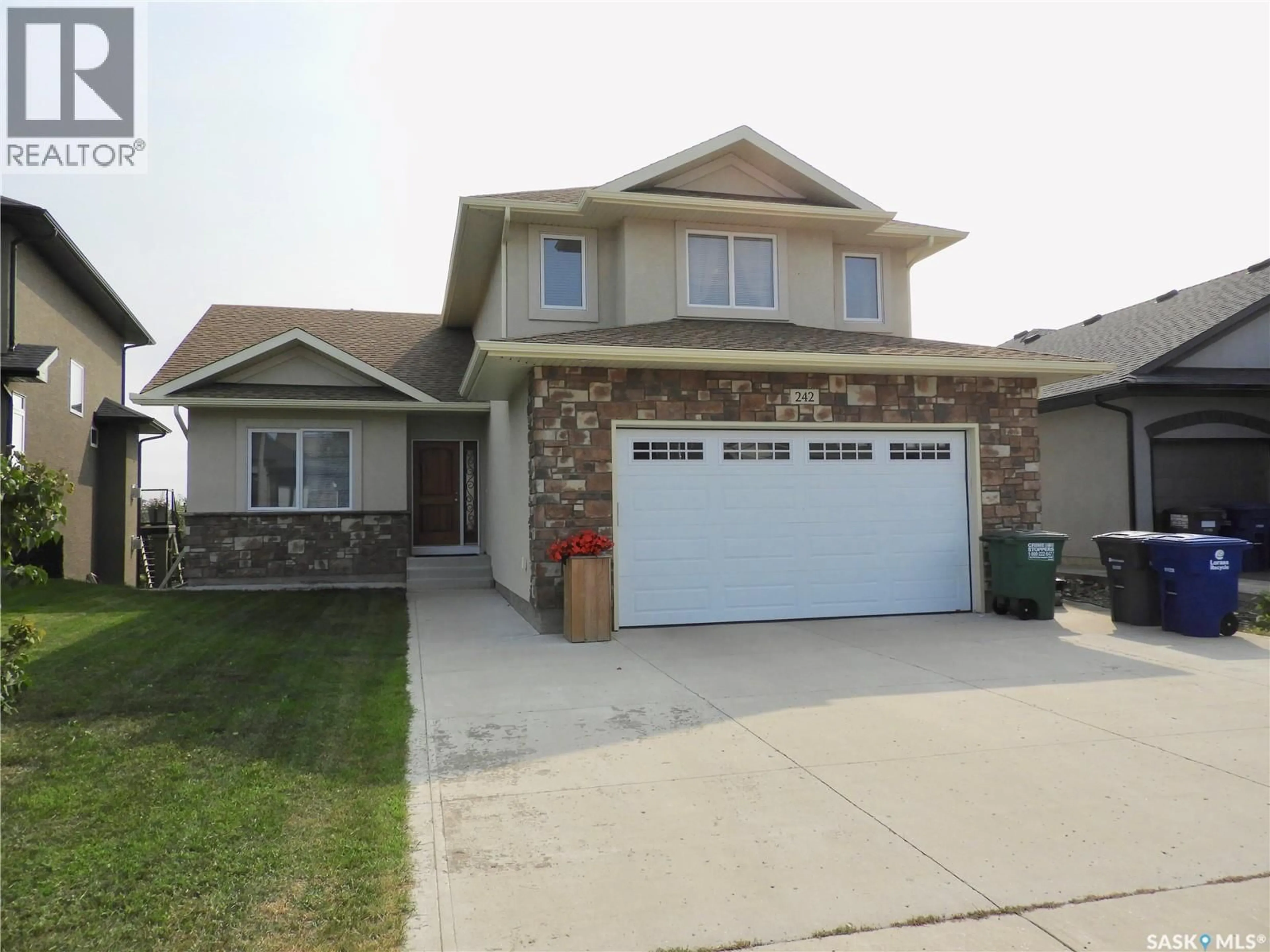 Home with vinyl exterior material, street for 242 WHALLEY CRESCENT, Saskatoon Saskatchewan S7T0N9
