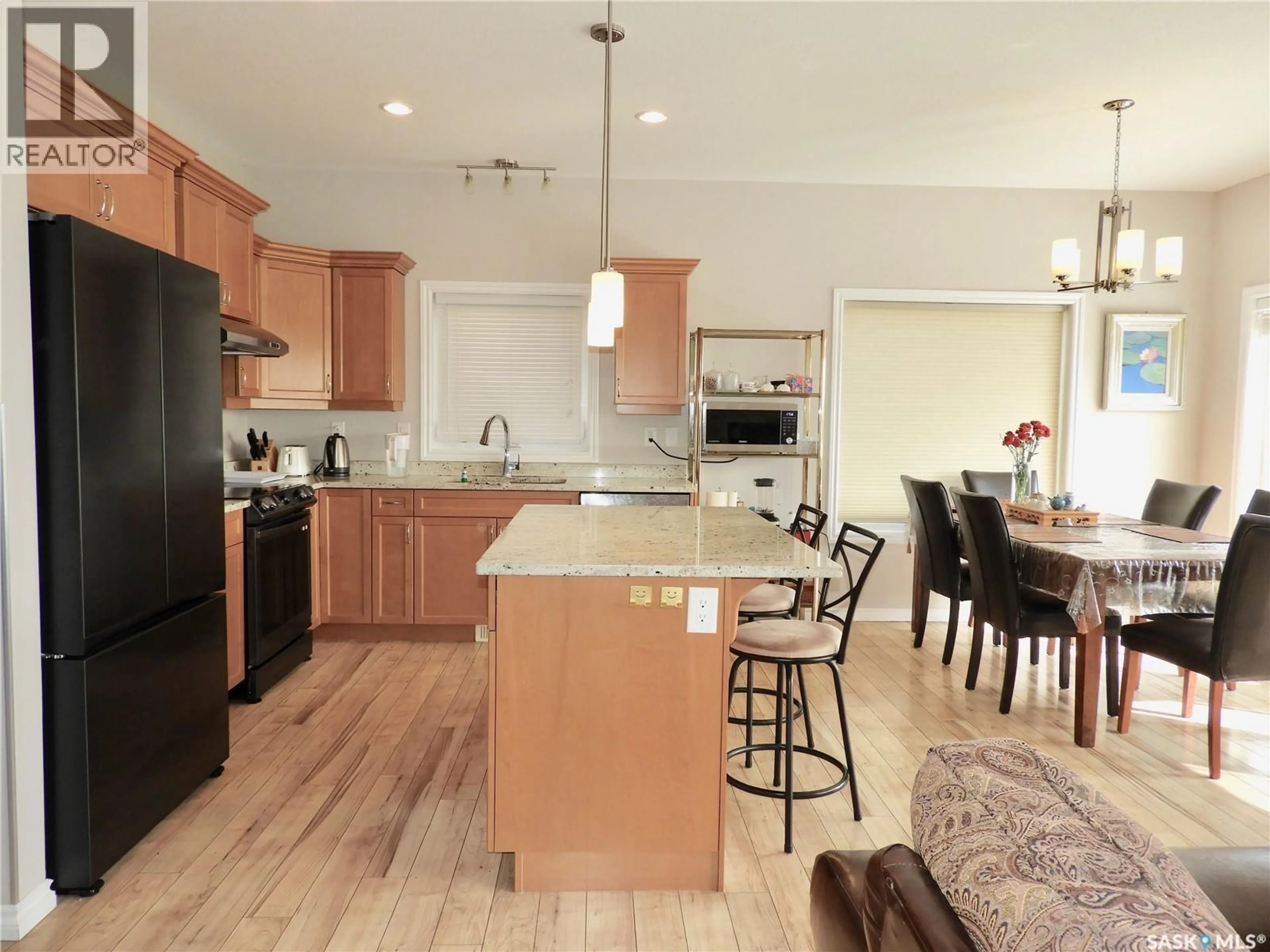 Open concept kitchen, wood/laminate floor for 242 WHALLEY CRESCENT, Saskatoon Saskatchewan S7T0N9