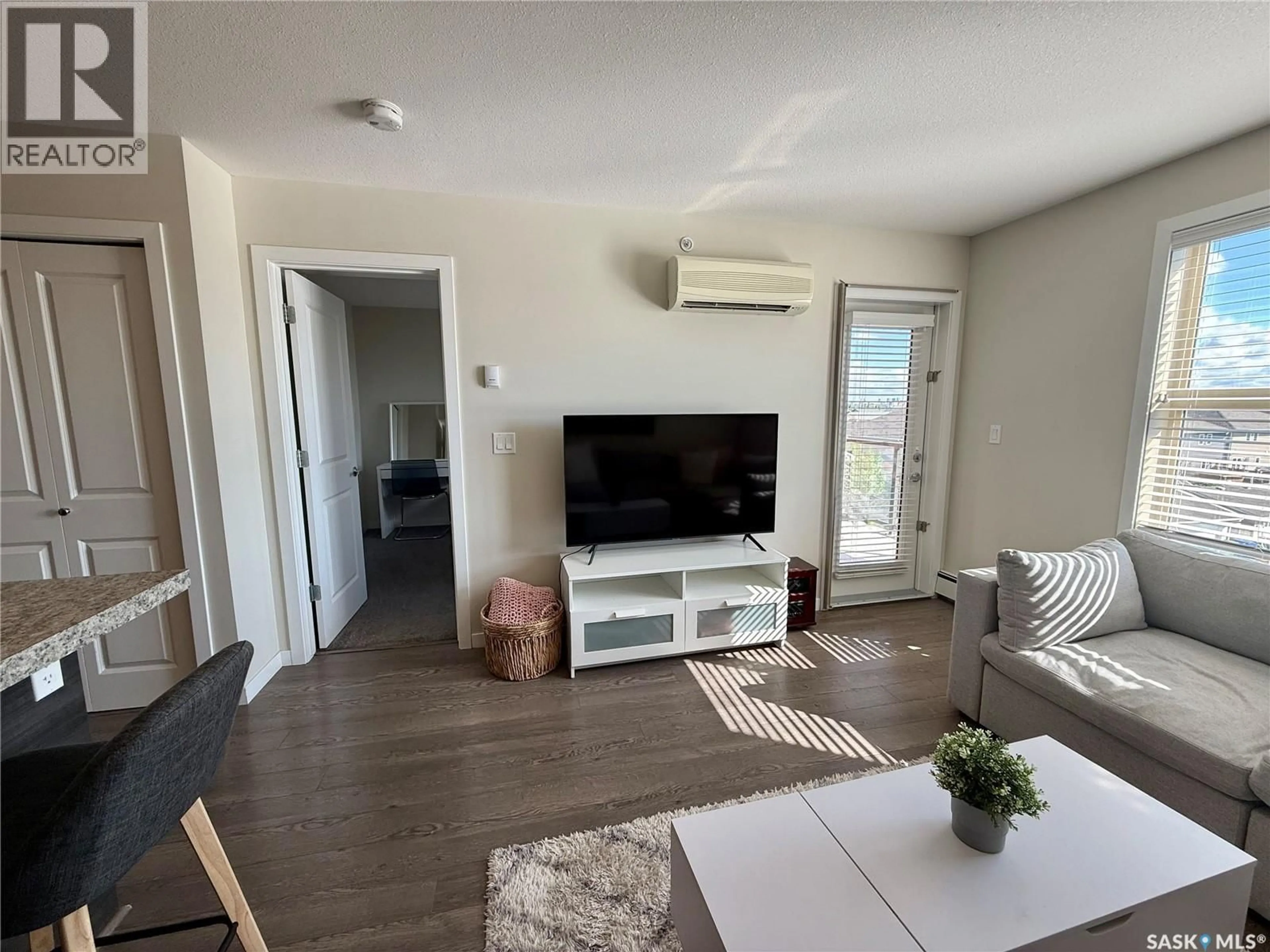 Living room with furniture, wood/laminate floor for 5500 - 1425 MITCHINSON WAY, Regina Saskatchewan S4W0N9