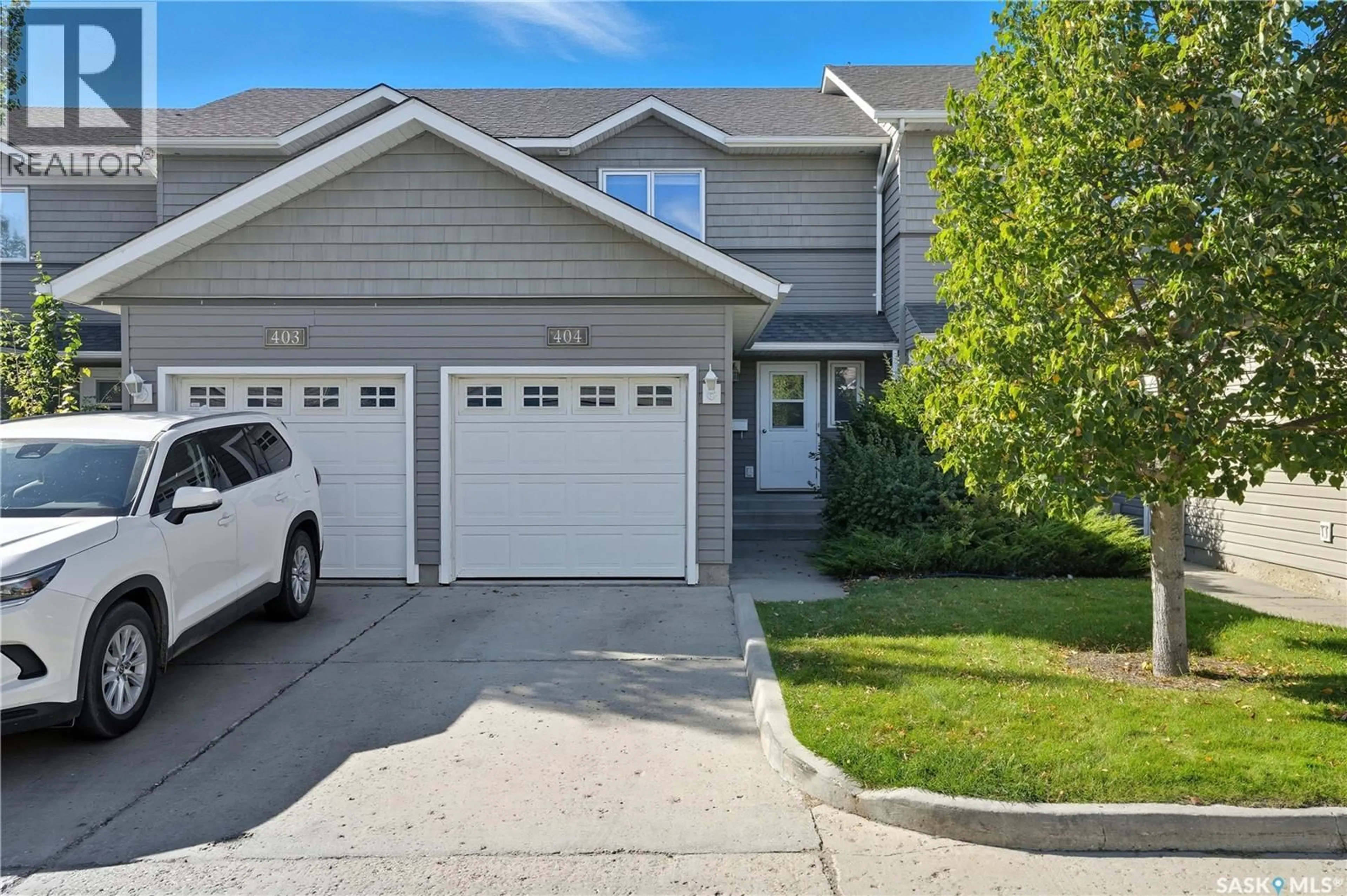 Home with vinyl exterior material, street for 404 715 HART ROAD, Saskatoon Saskatchewan S7M3Y7