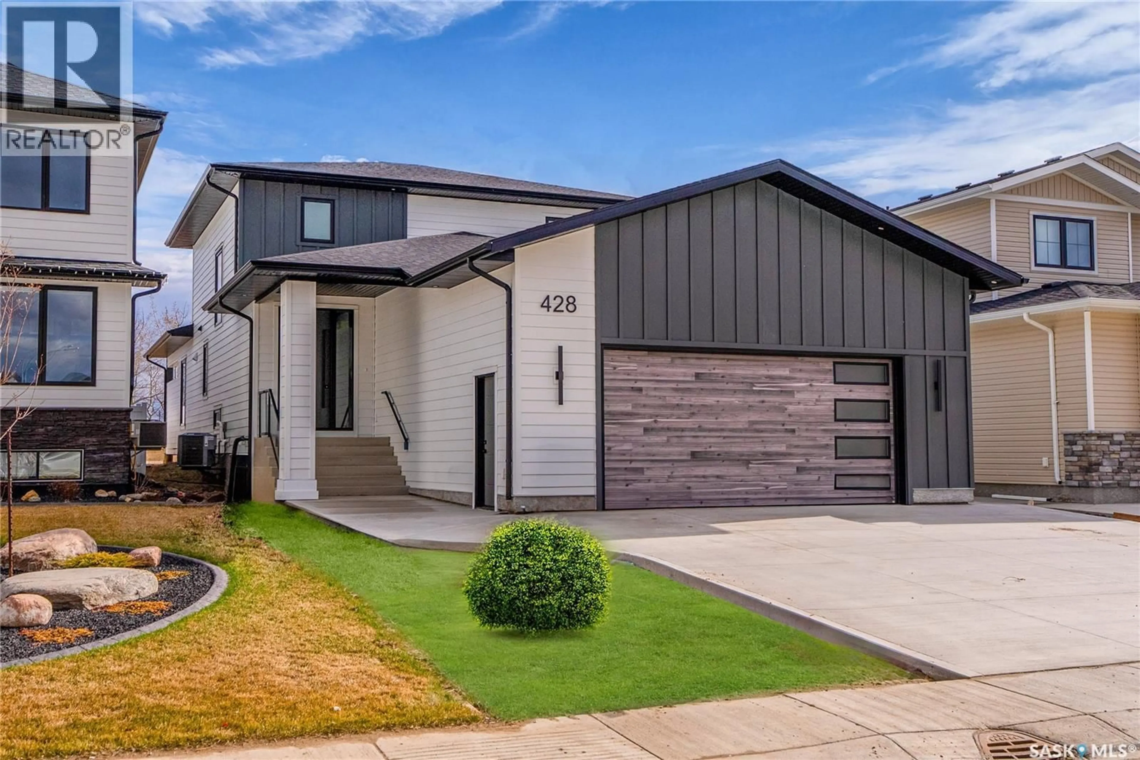 Home with vinyl exterior material, street for 428 WOOLF BEND, Saskatoon Saskatchewan S7W1E5