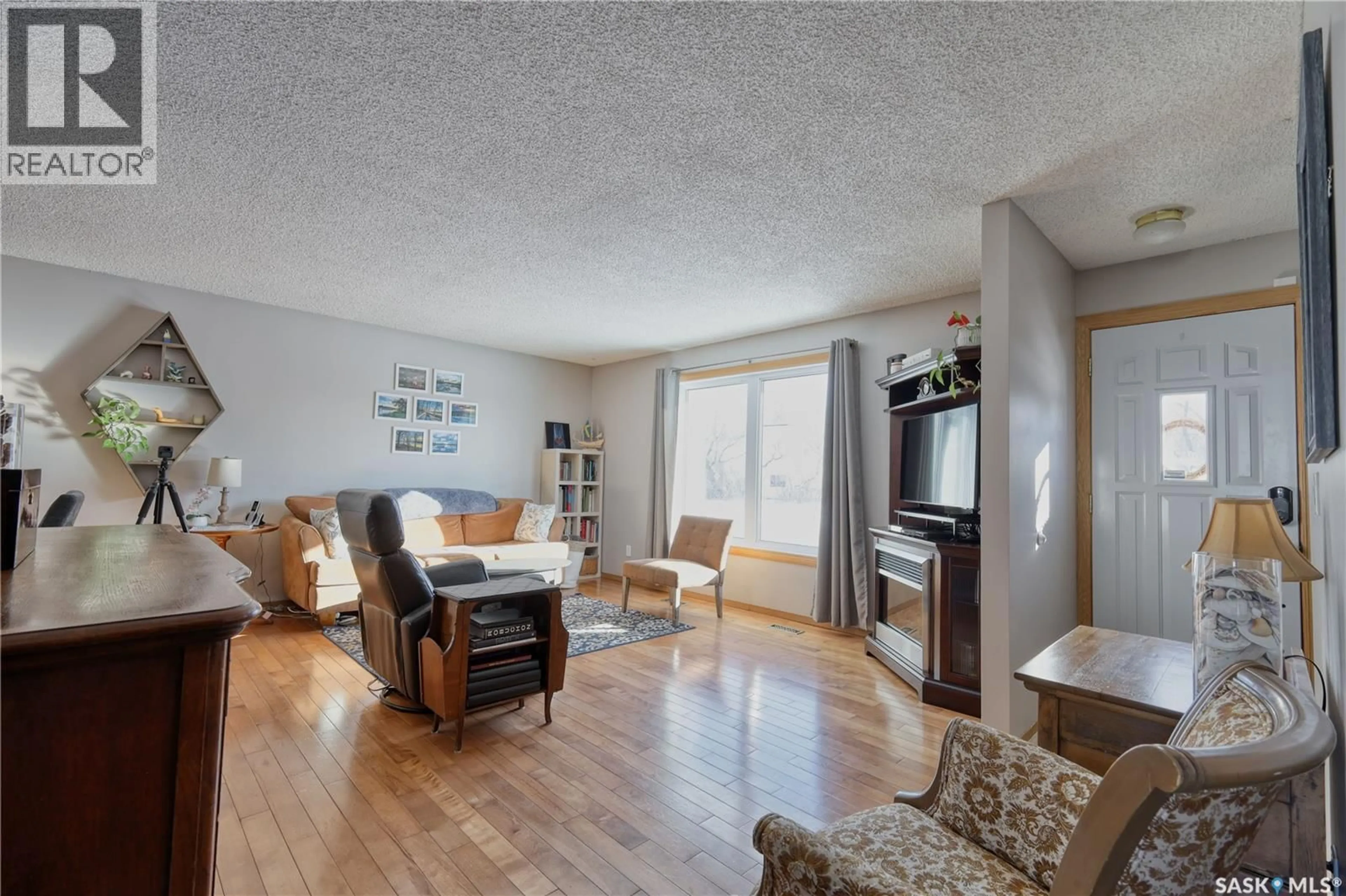 Living room with furniture, wood/laminate floor for 101 3RD STREET, Langham Saskatchewan S0K2K0