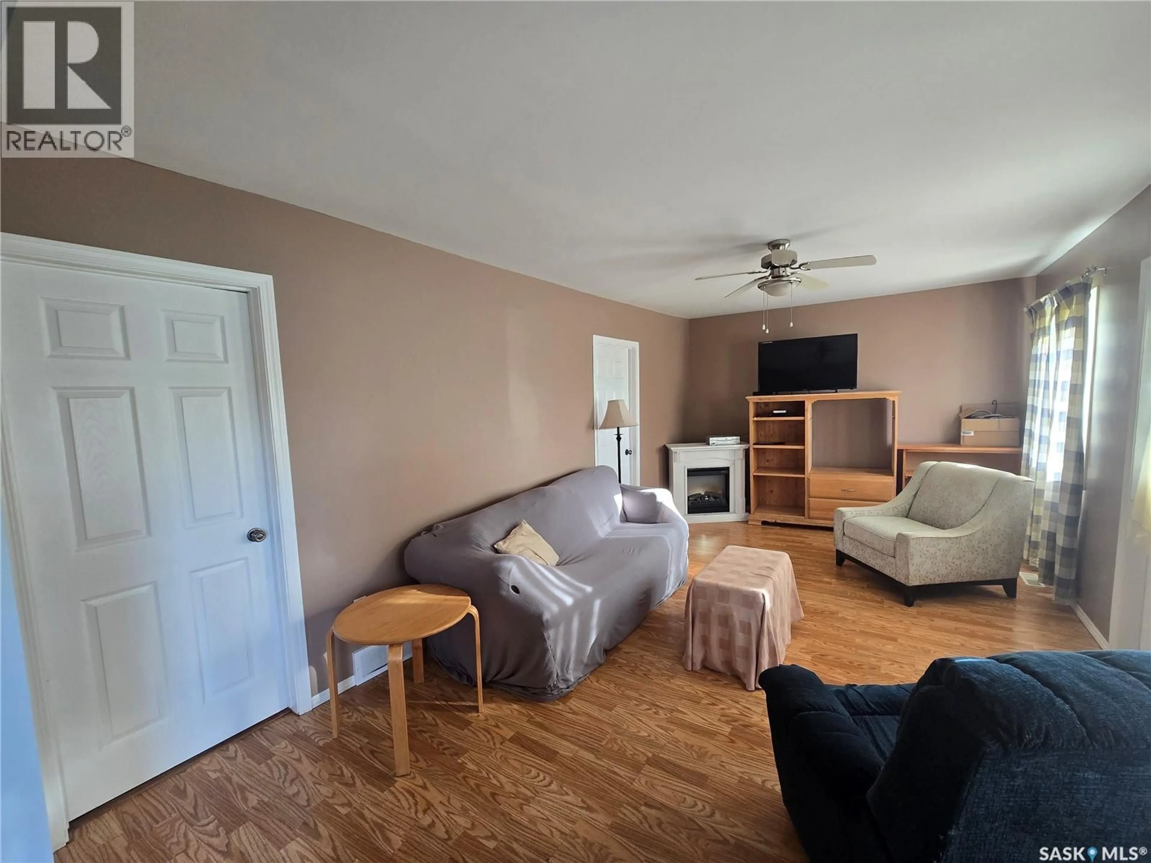 Living room with furniture, wood/laminate floor for 315 GOVERNMENT ROAD, Stoughton Saskatchewan S0G4T0