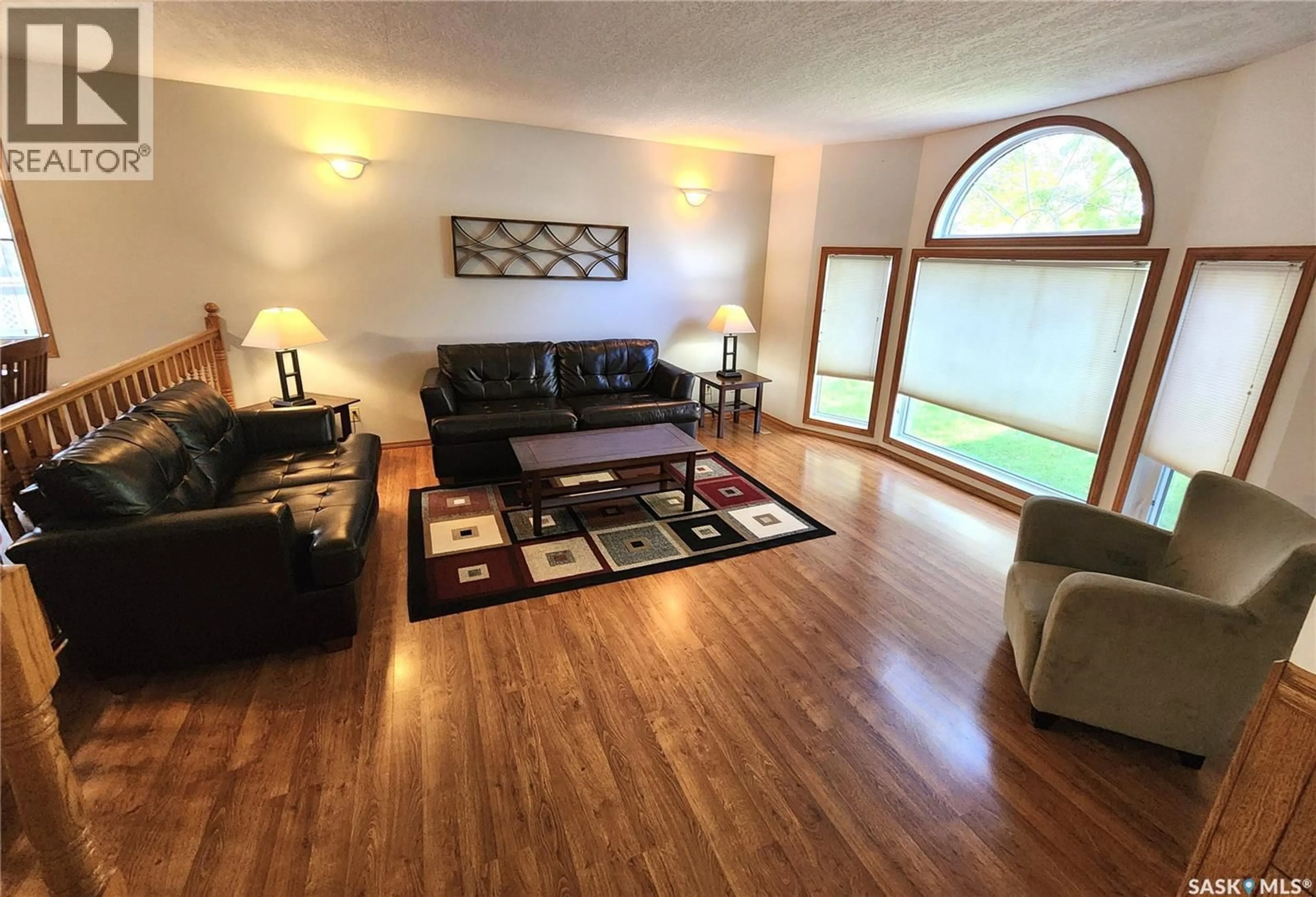 Living room with furniture, wood/laminate floor for 514 1ST AVENUE, Lampman Saskatchewan S0C1N0