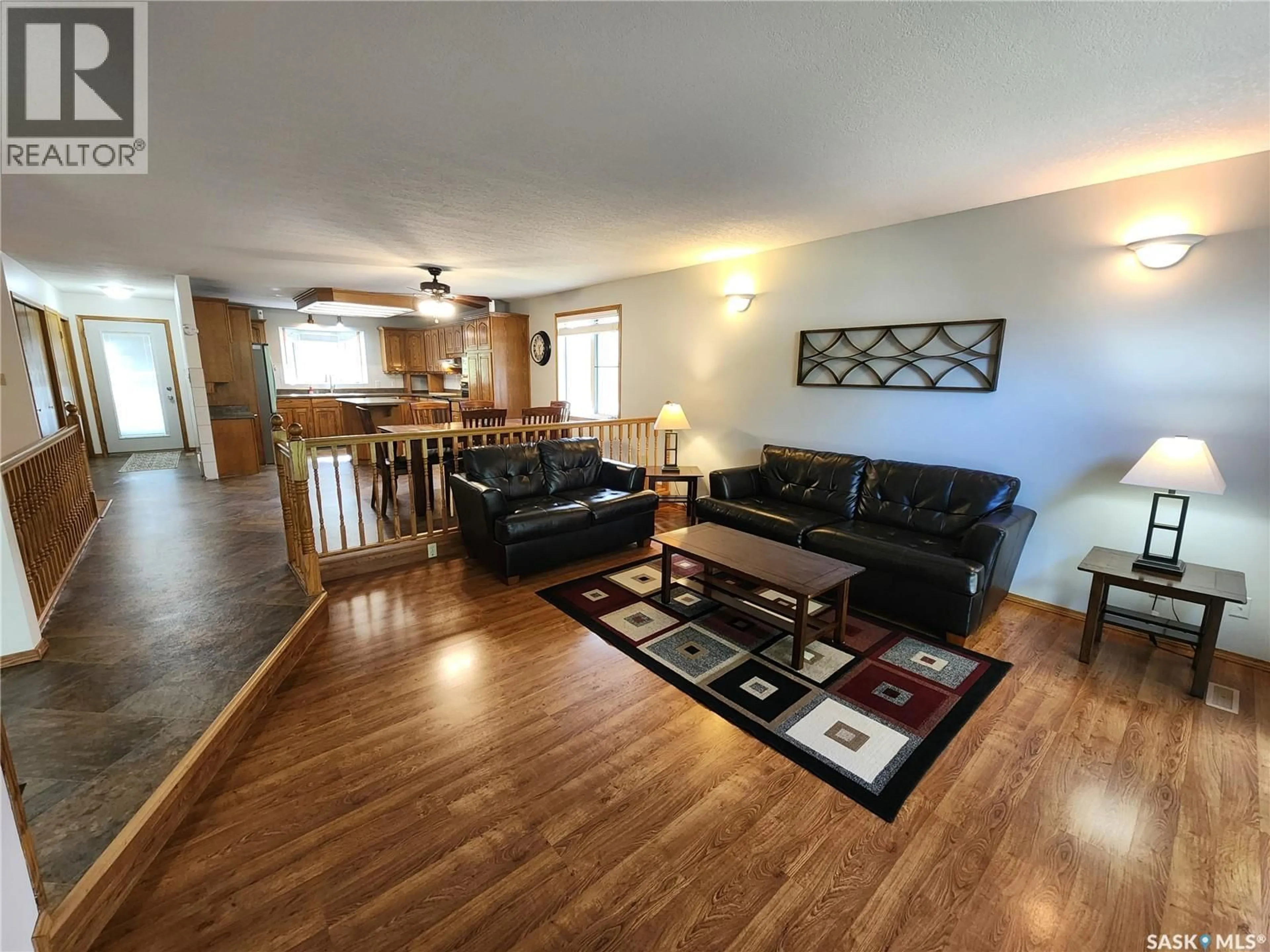 Living room with furniture, wood/laminate floor for 514 1ST AVENUE, Lampman Saskatchewan S0C1N0
