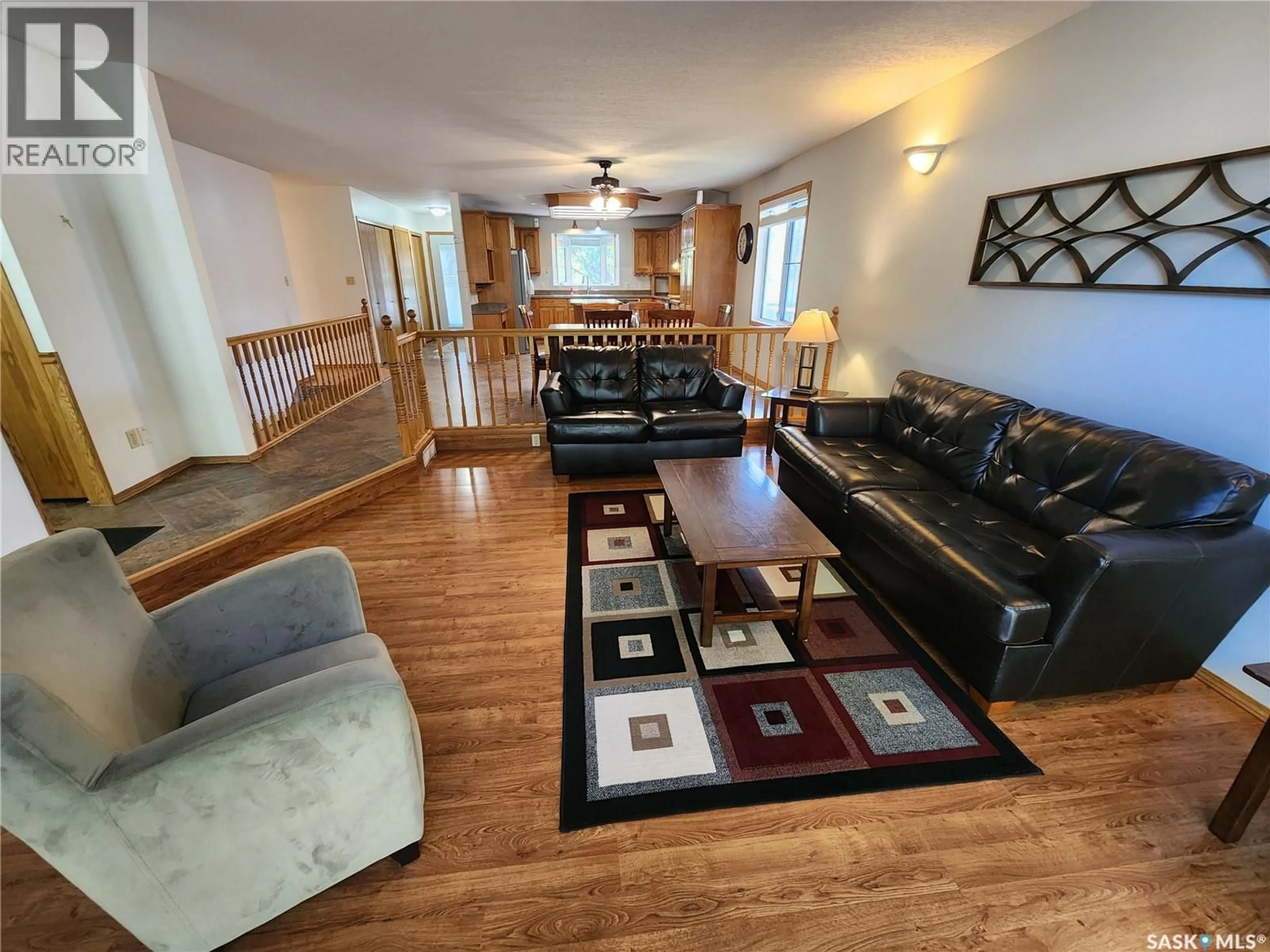 Living room with furniture, wood/laminate floor for 514 1ST AVENUE, Lampman Saskatchewan S0C1N0