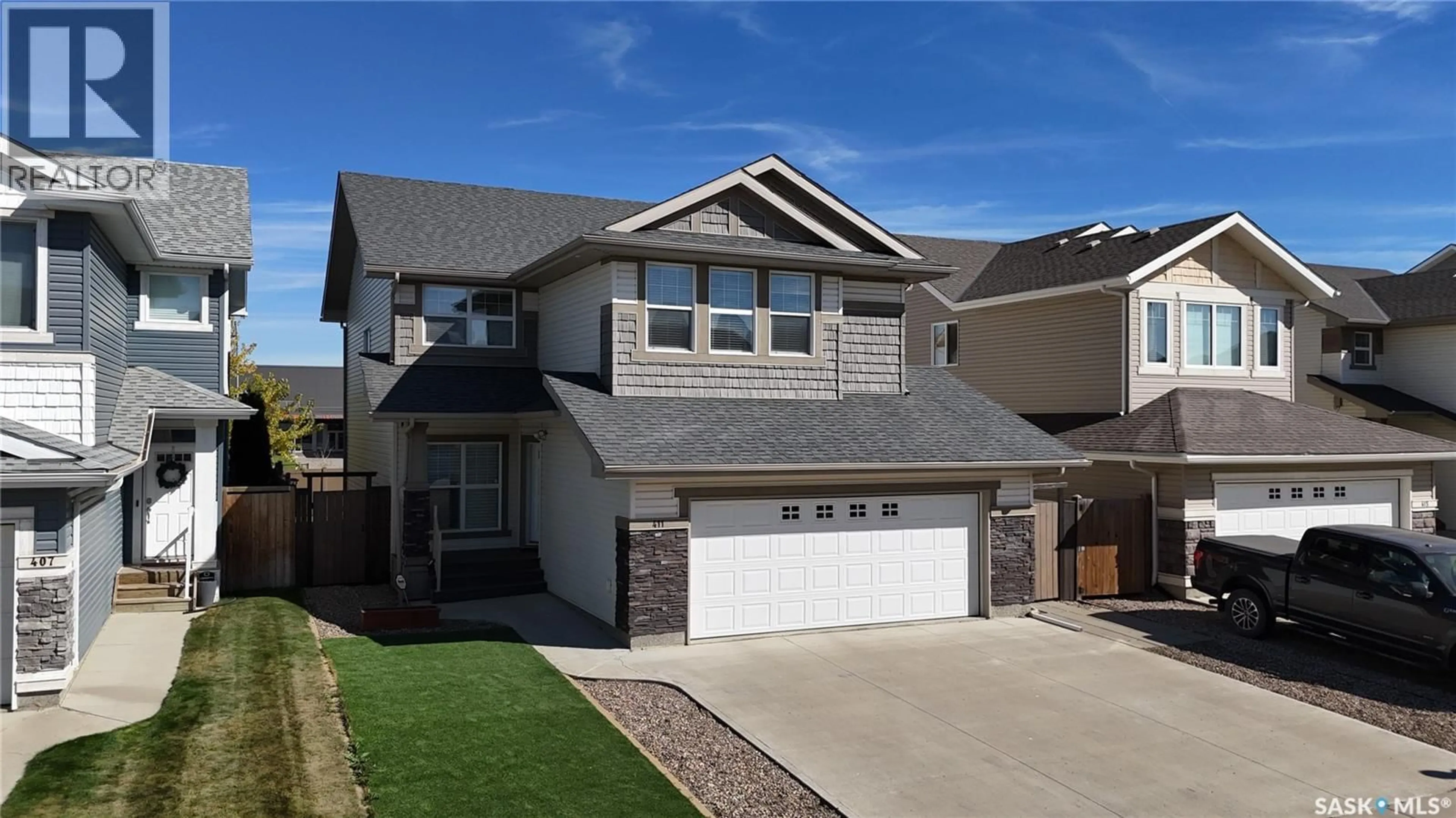 Home with vinyl exterior material, street for 411 FLYNN LANE, Saskatoon Saskatchewan S7V0L1