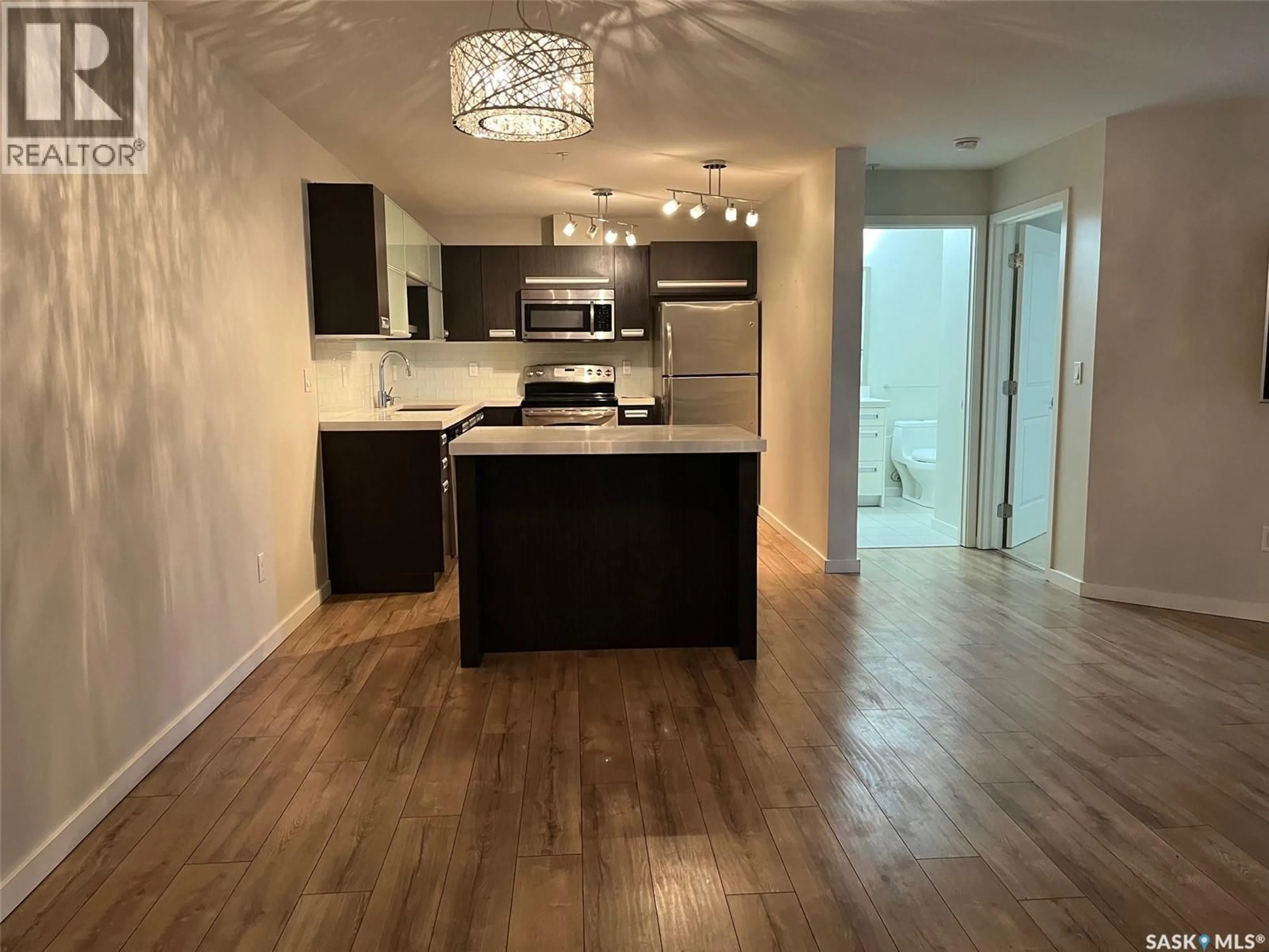 Open concept kitchen, wood/laminate floor for 117 - 1610 DAKOTA DRIVE, Regina Saskatchewan S4Z0A5