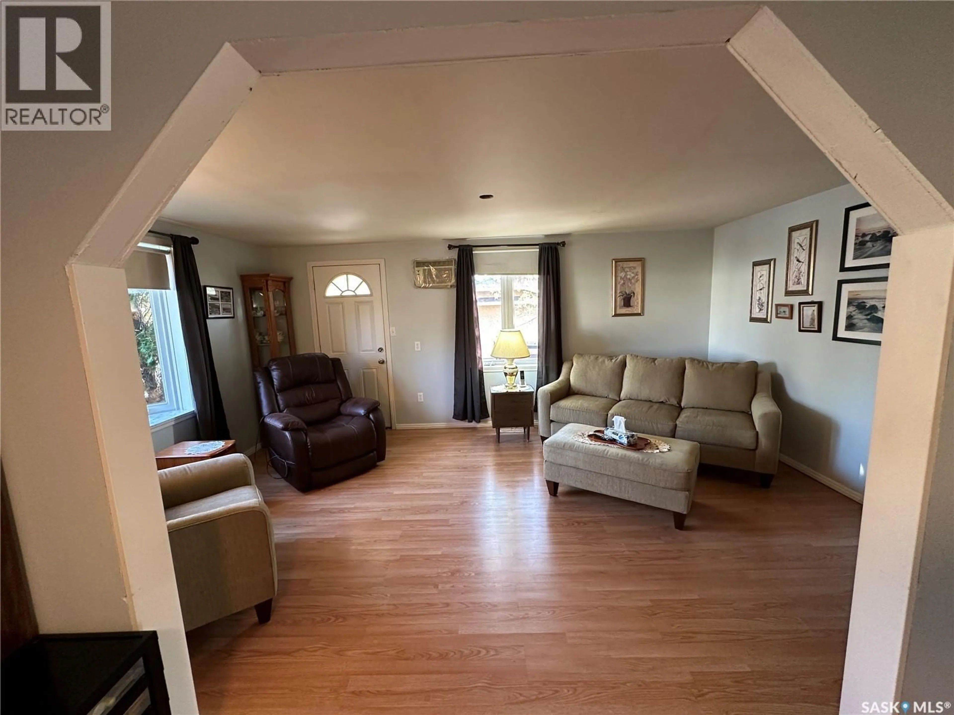 Living room with furniture, wood/laminate floor for 408 5TH AVENUE, Rosthern Saskatchewan S0K3R0