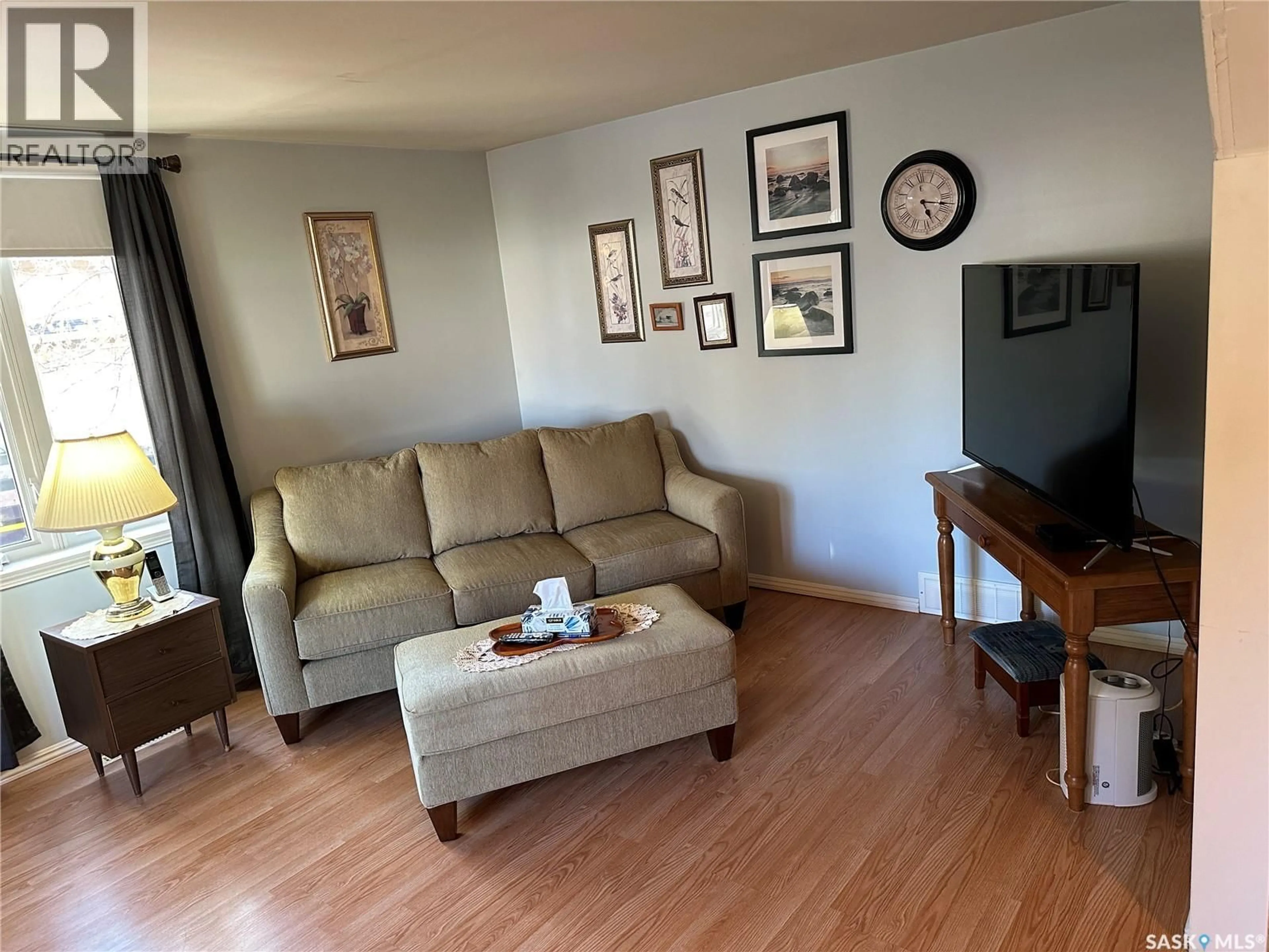 Living room with furniture, wood/laminate floor for 408 5TH AVENUE, Rosthern Saskatchewan S0K3R0