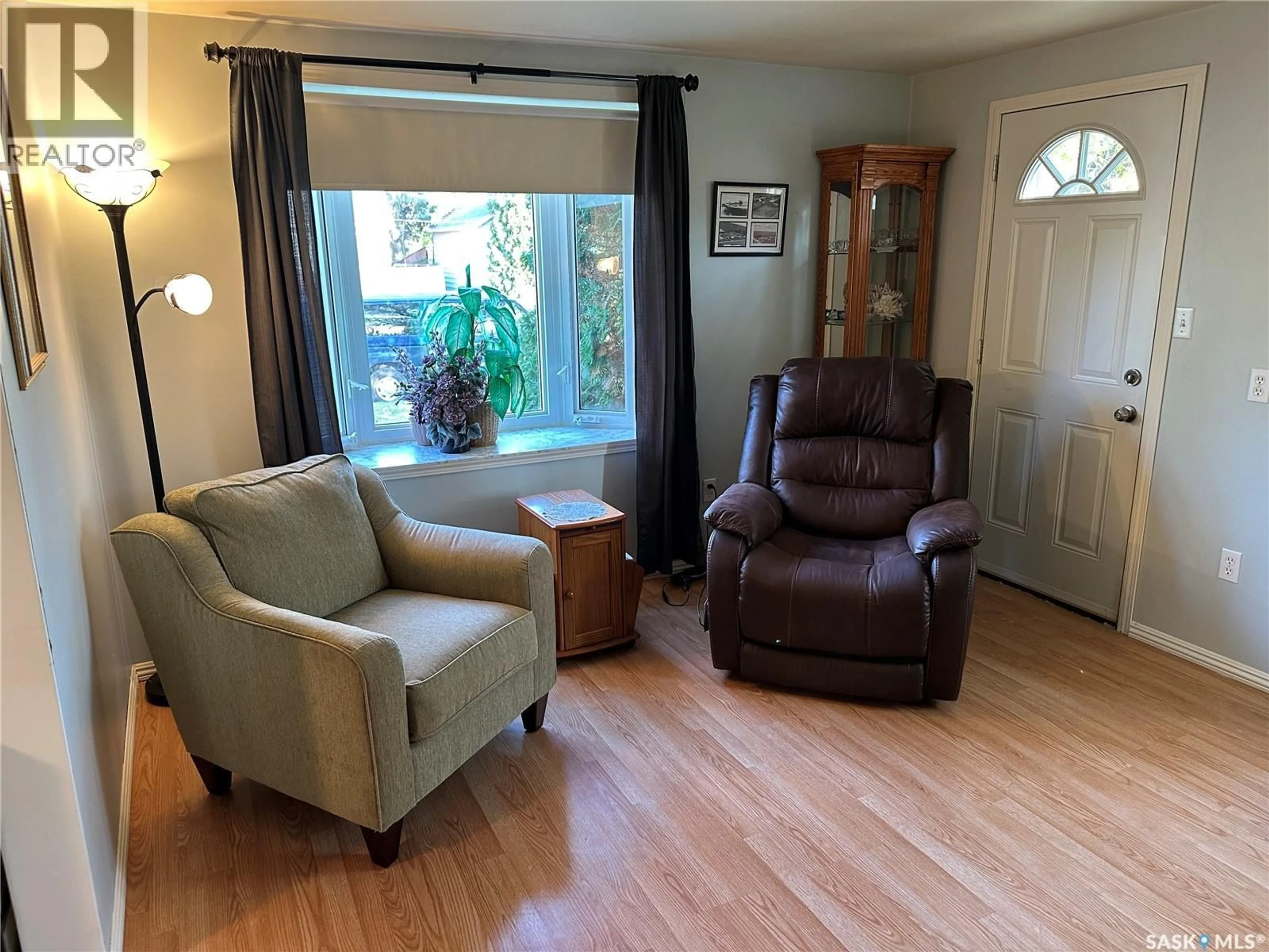 Living room with furniture, wood/laminate floor for 408 5TH AVENUE, Rosthern Saskatchewan S0K3R0