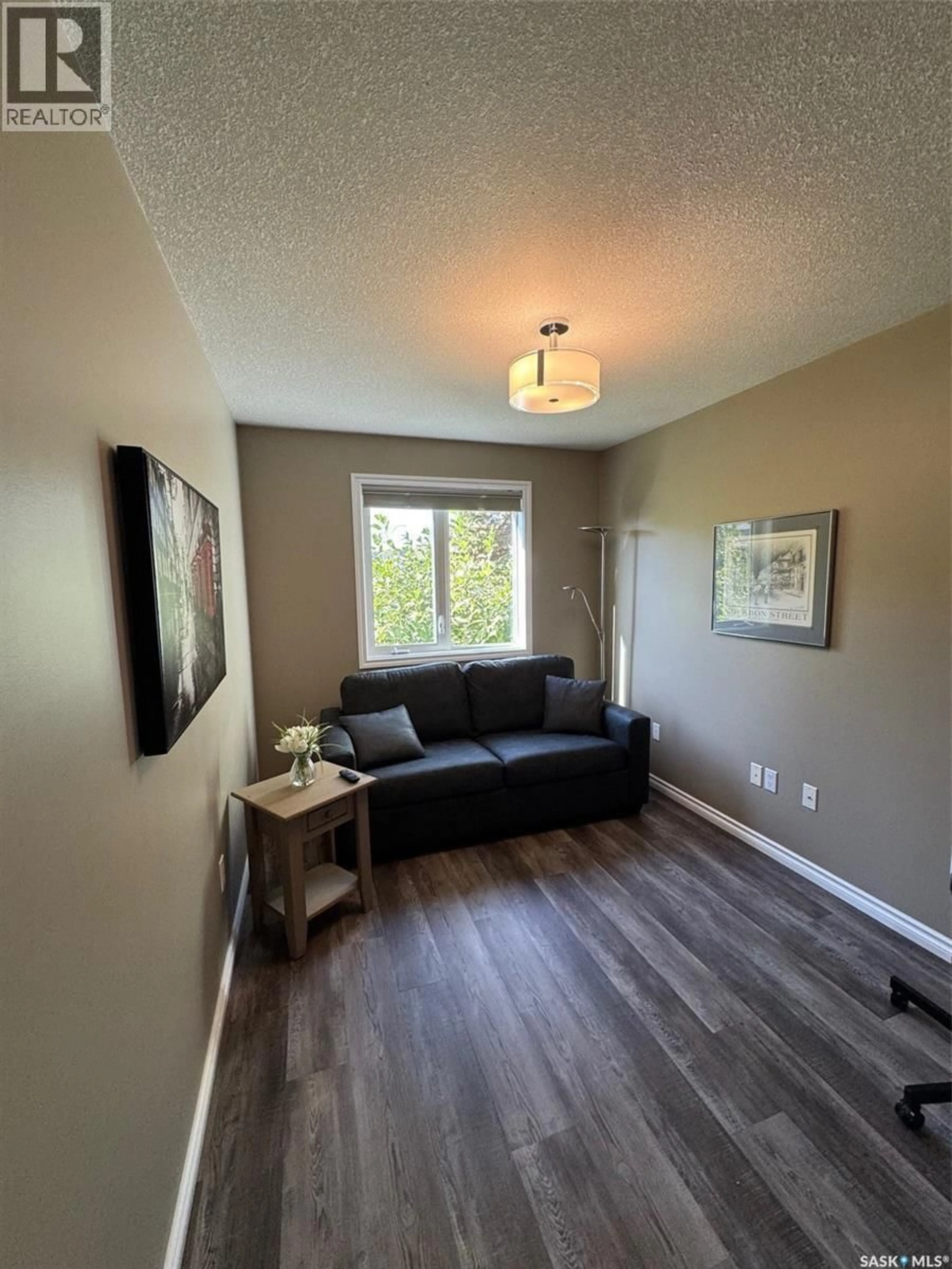 Living room with furniture, wood/laminate floor for 175 JANET PLACE, Battleford Saskatchewan S0M0E0