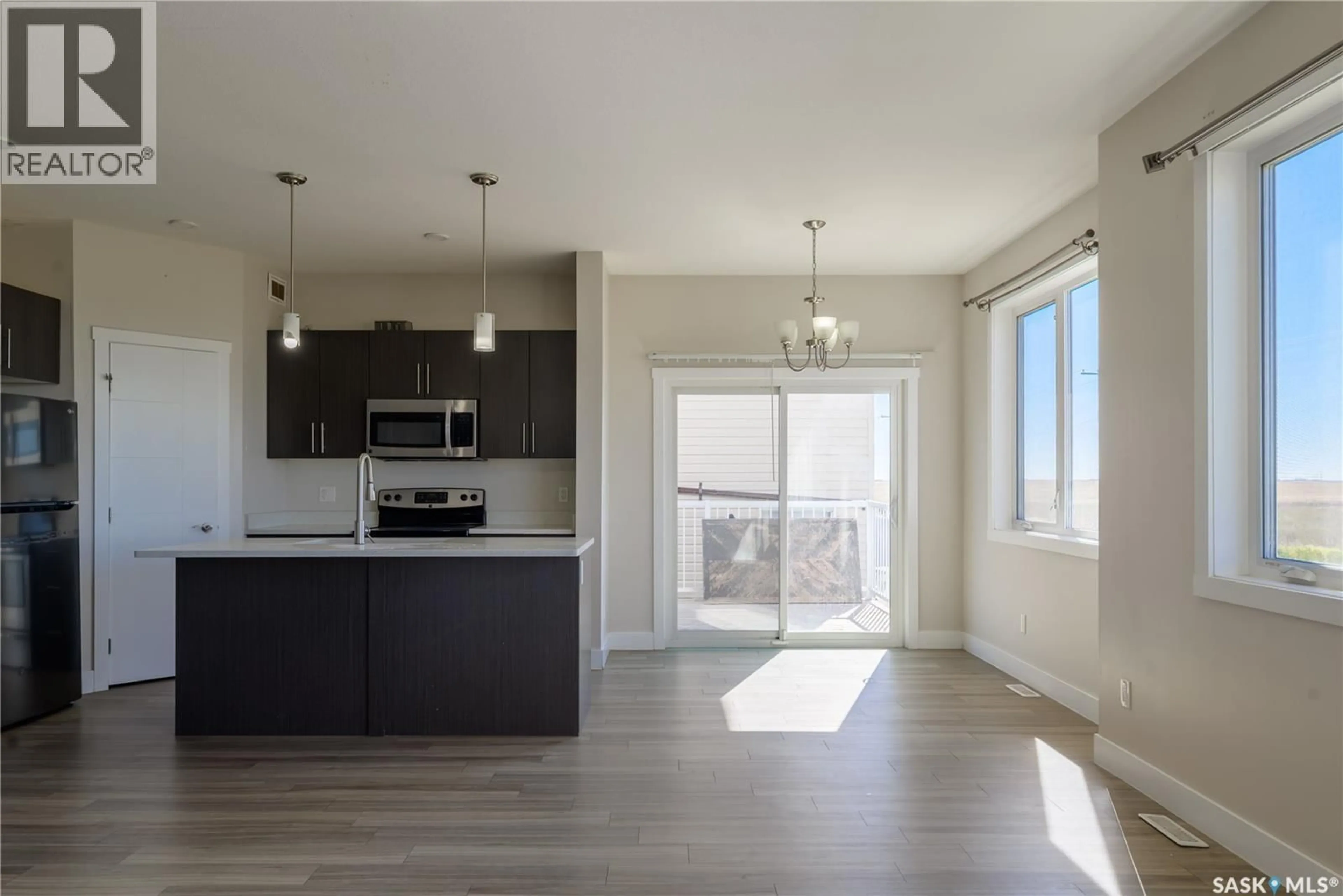 Open concept kitchen, wood/laminate floor for 5707 GLIDE CRESCENT, Regina Saskatchewan S4W0P2
