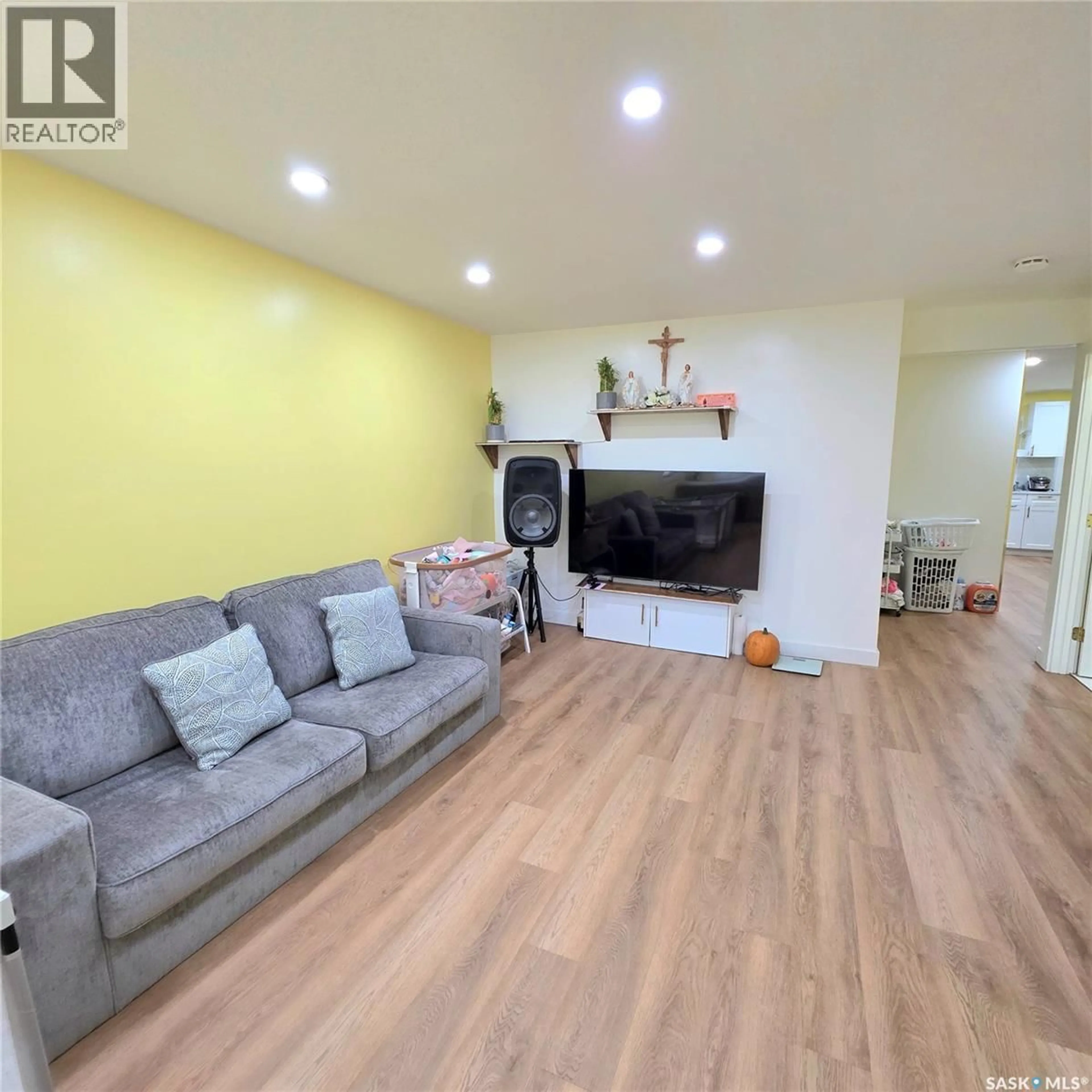 Living room with furniture, wood/laminate floor for 438 22ND STREET, Prince Albert Saskatchewan S6V1N5