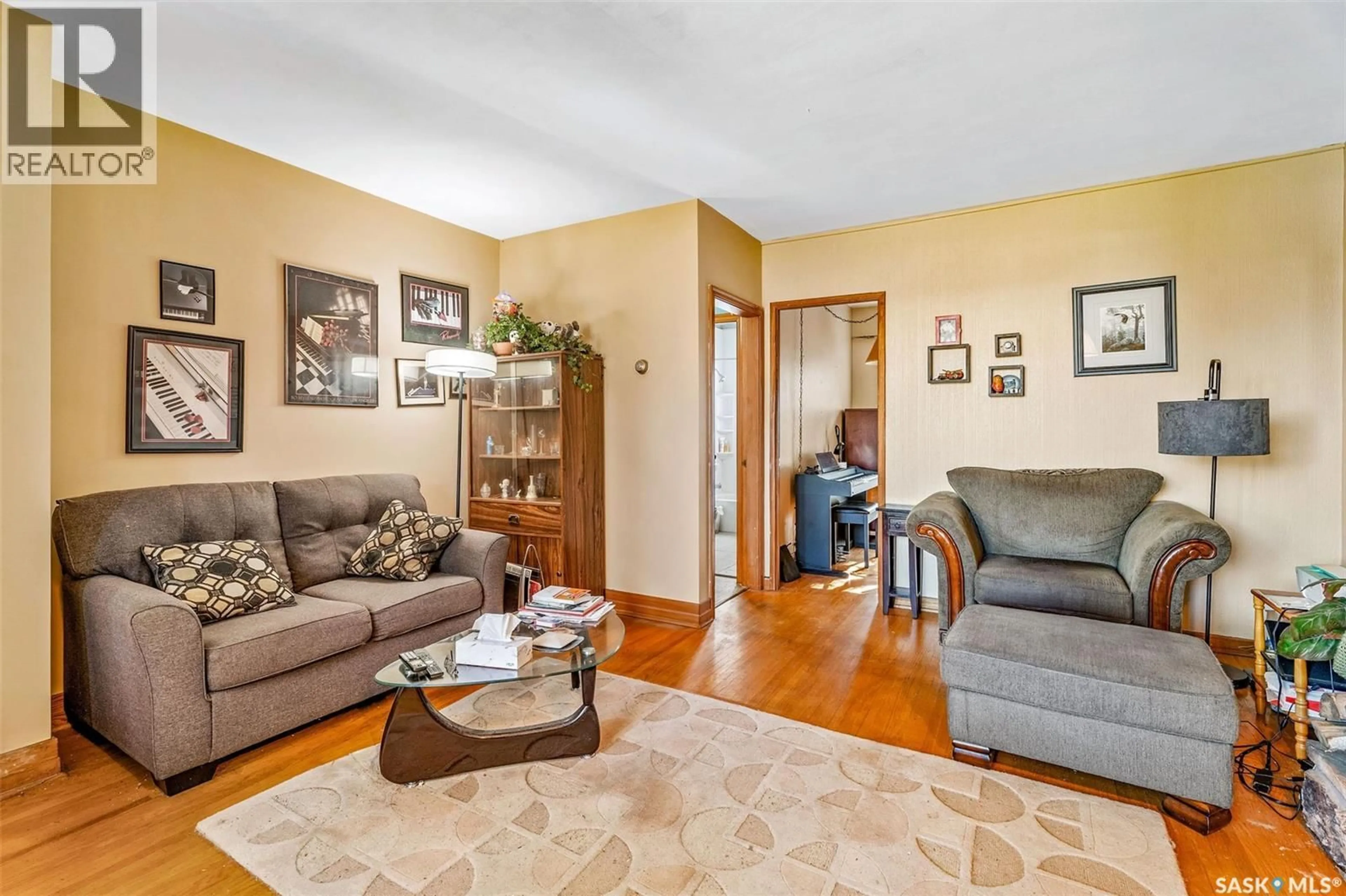 Living room with furniture, wood/laminate floor for 135 21ST STREET, Prince Albert Saskatchewan S6V4H8