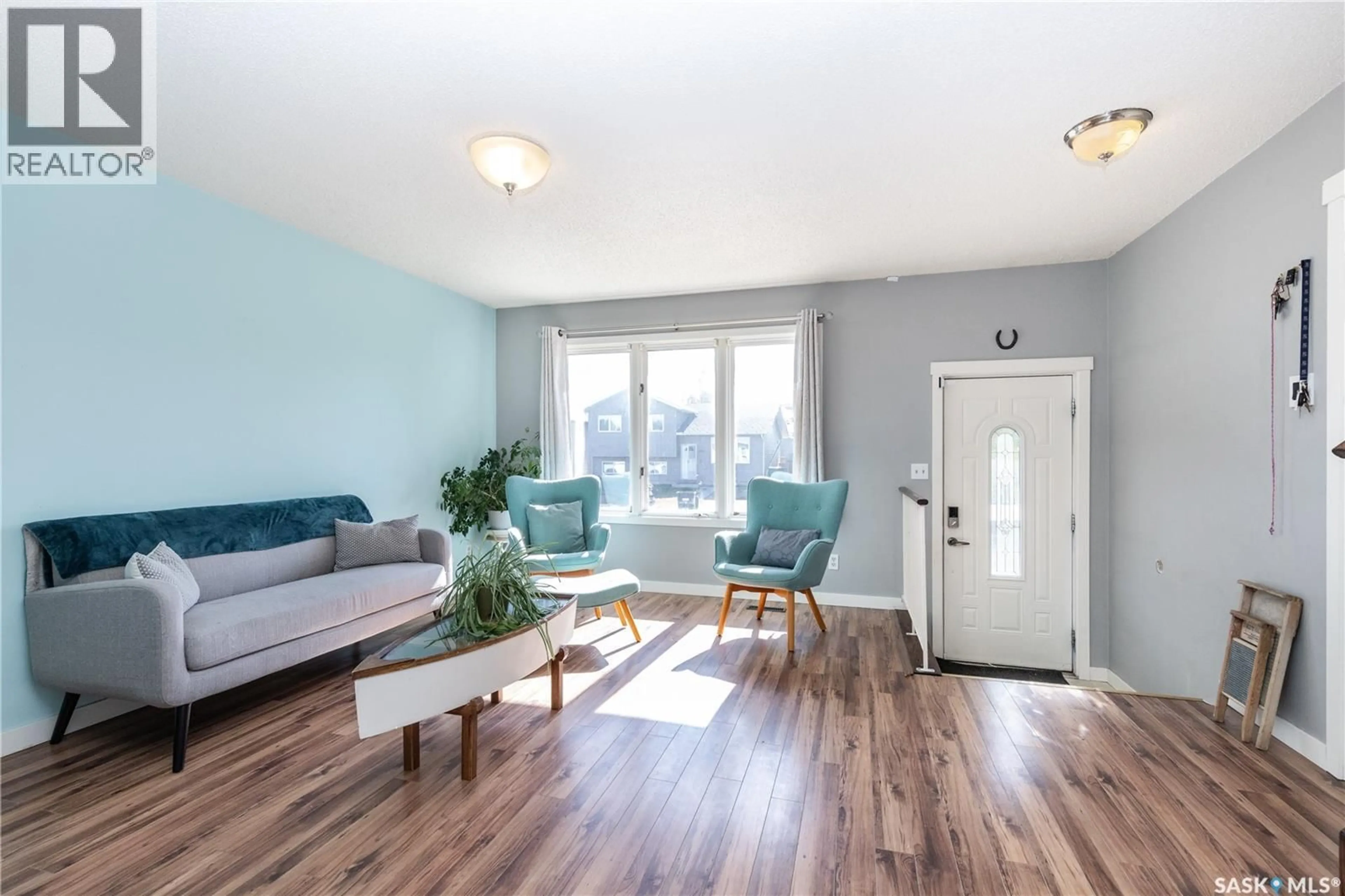 Living room with furniture, wood/laminate floor for 734 WHELAN WAY, Saskatoon Saskatchewan S7L7E5
