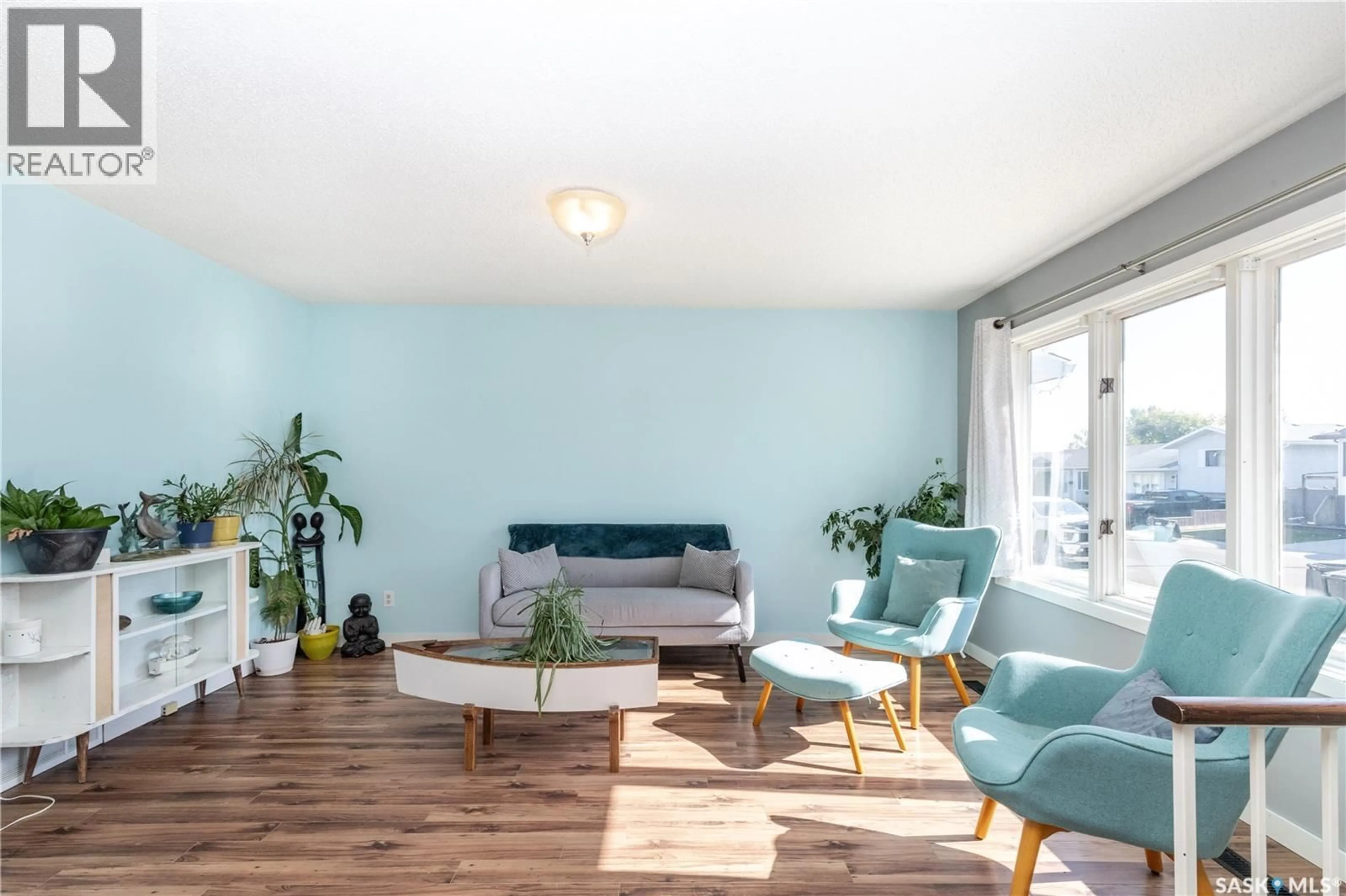Living room with furniture, wood/laminate floor for 734 WHELAN WAY, Saskatoon Saskatchewan S7L7E5