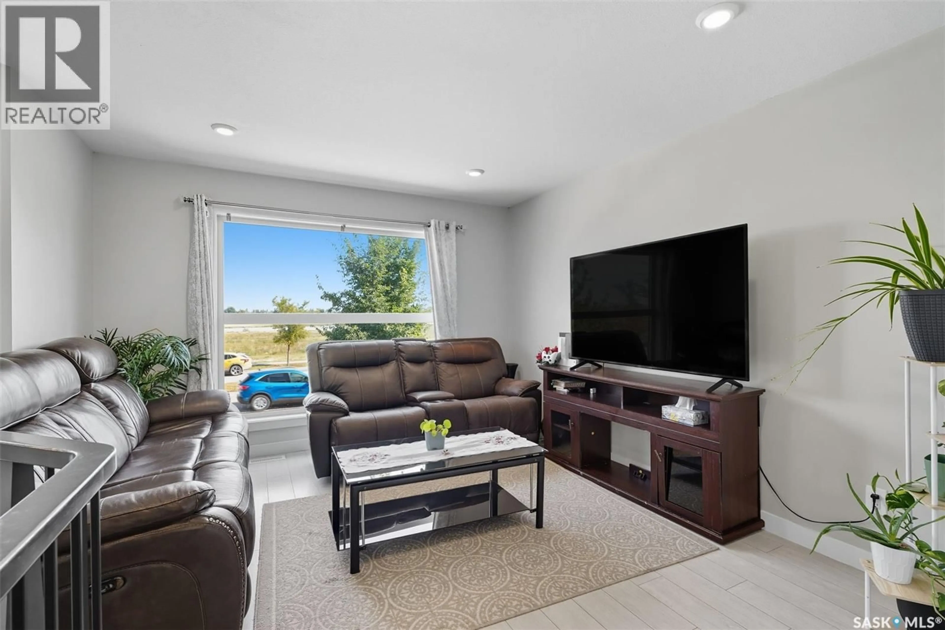 Living room with furniture, ceramic/tile floor for 4127 33RD STREET, Saskatoon Saskatchewan S7R0M4