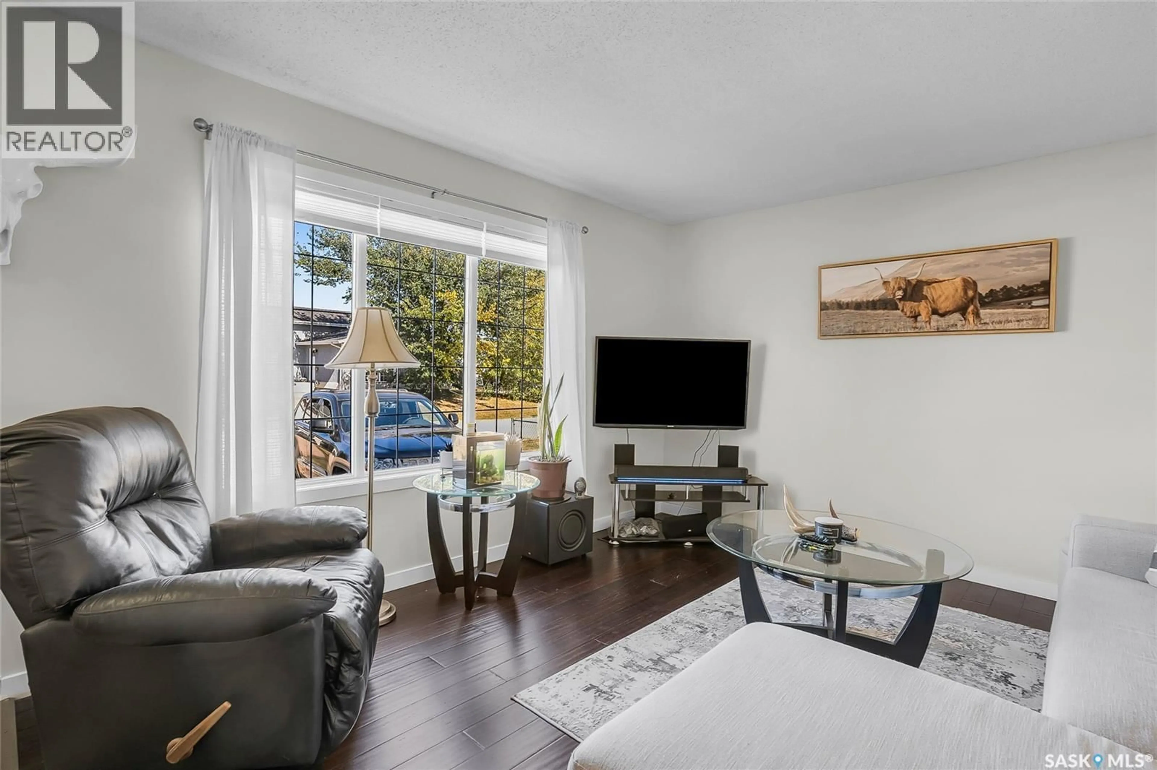 Living room with furniture, wood/laminate floor for 104 4TH STREET, Dundurn Saskatchewan S0K1K0