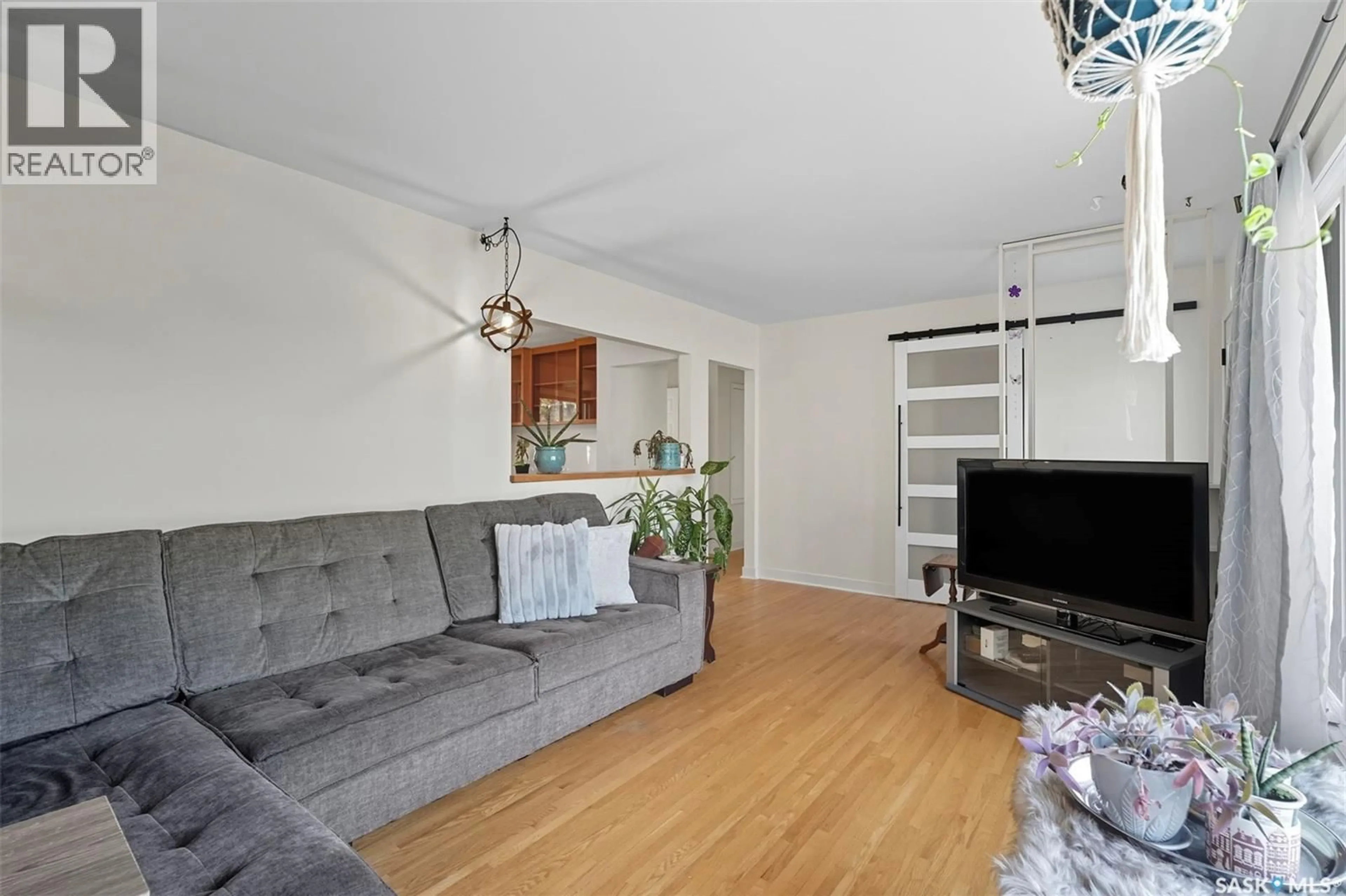 Living room with furniture, wood/laminate floor for 1710 PRESTON AVENUE, Saskatoon Saskatchewan S7H2V8