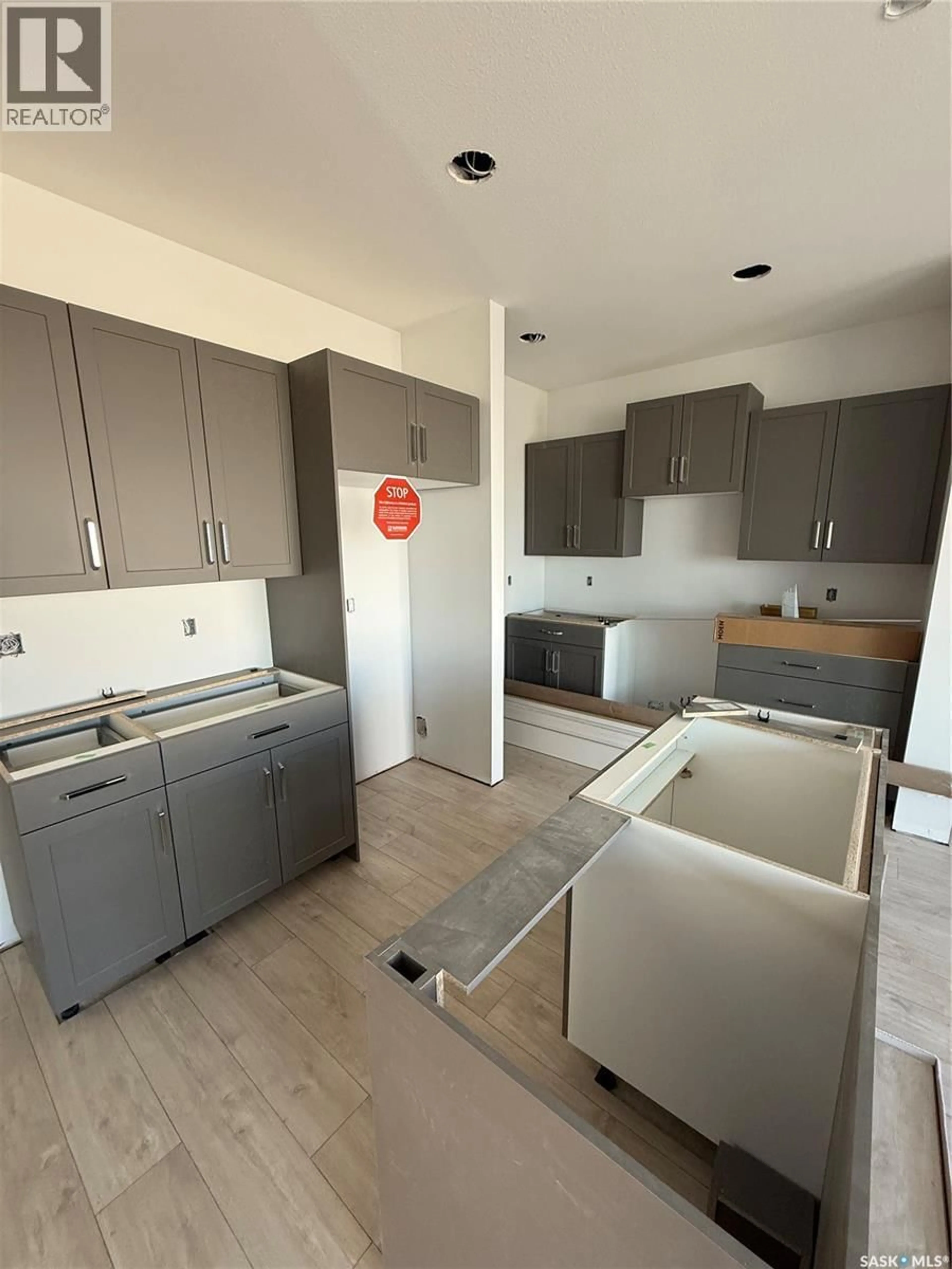 Open concept kitchen, wood/laminate floor for 167 HAVERSTOCK CRESCENT, Saskatoon Saskatchewan S7W1E3