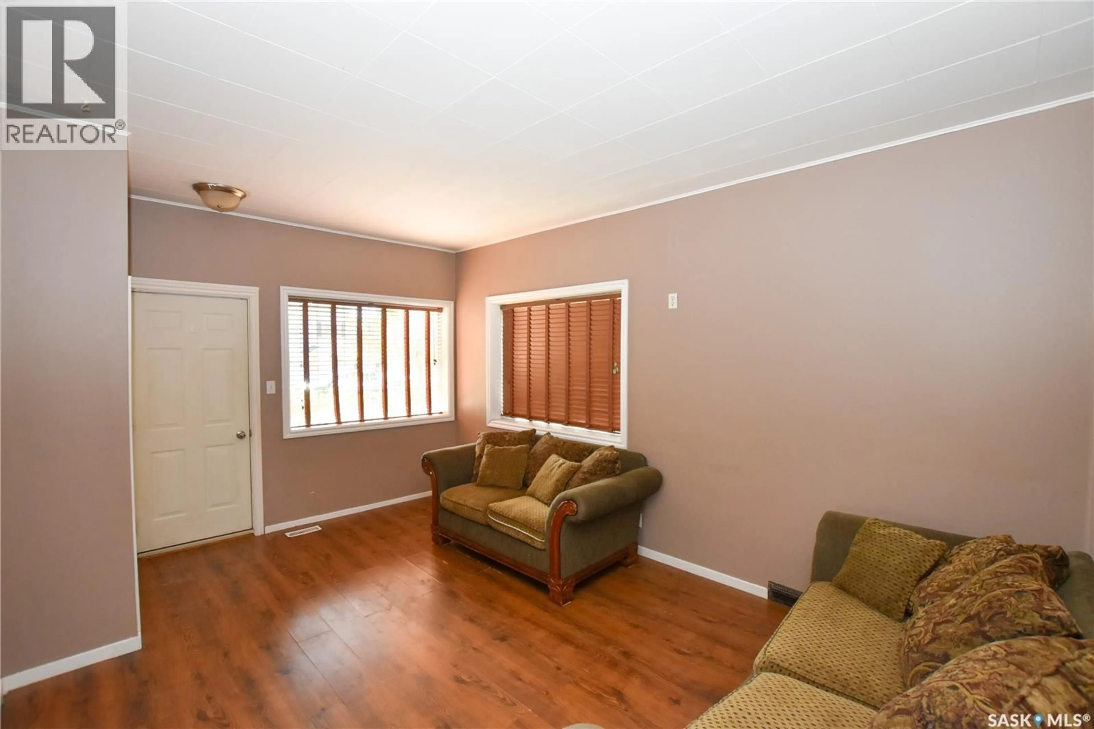 Living room with furniture, wood/laminate floor for 614 OMINICA STREET, Moose Jaw Saskatchewan S6H0H5