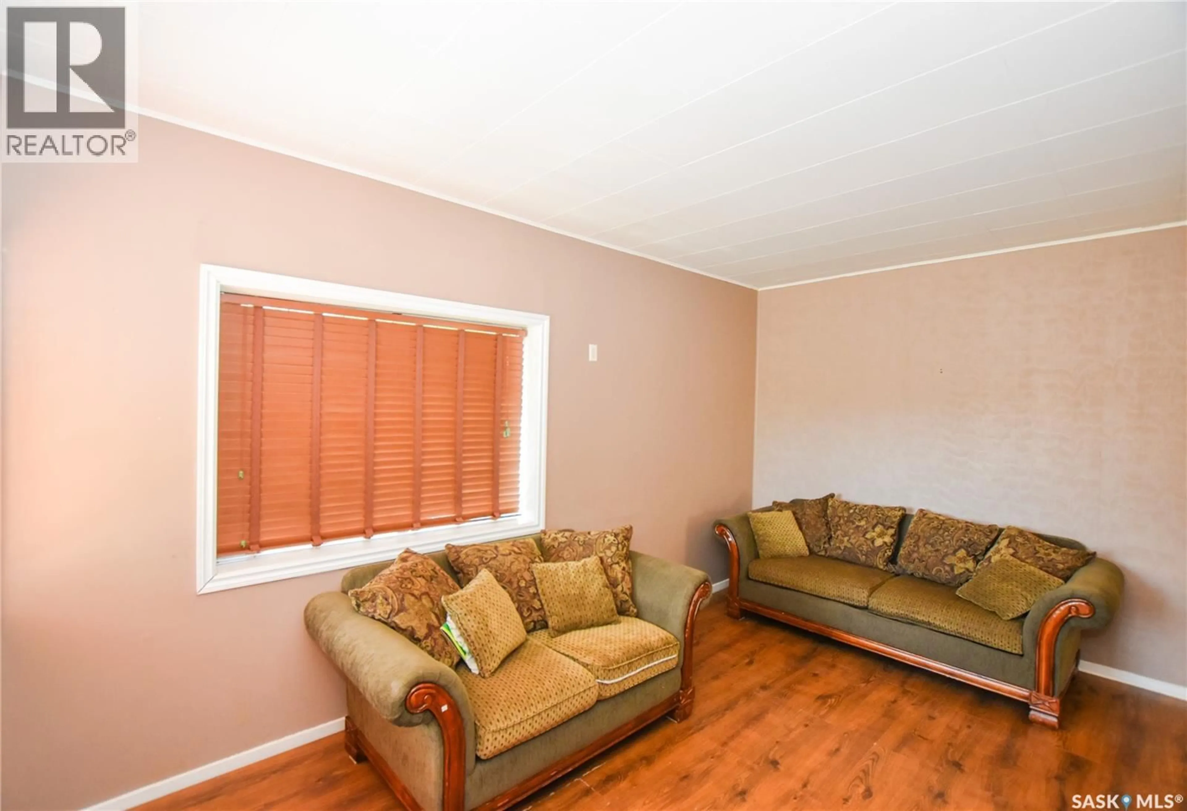 Living room with furniture, wood/laminate floor for 614 OMINICA STREET, Moose Jaw Saskatchewan S6H0H5