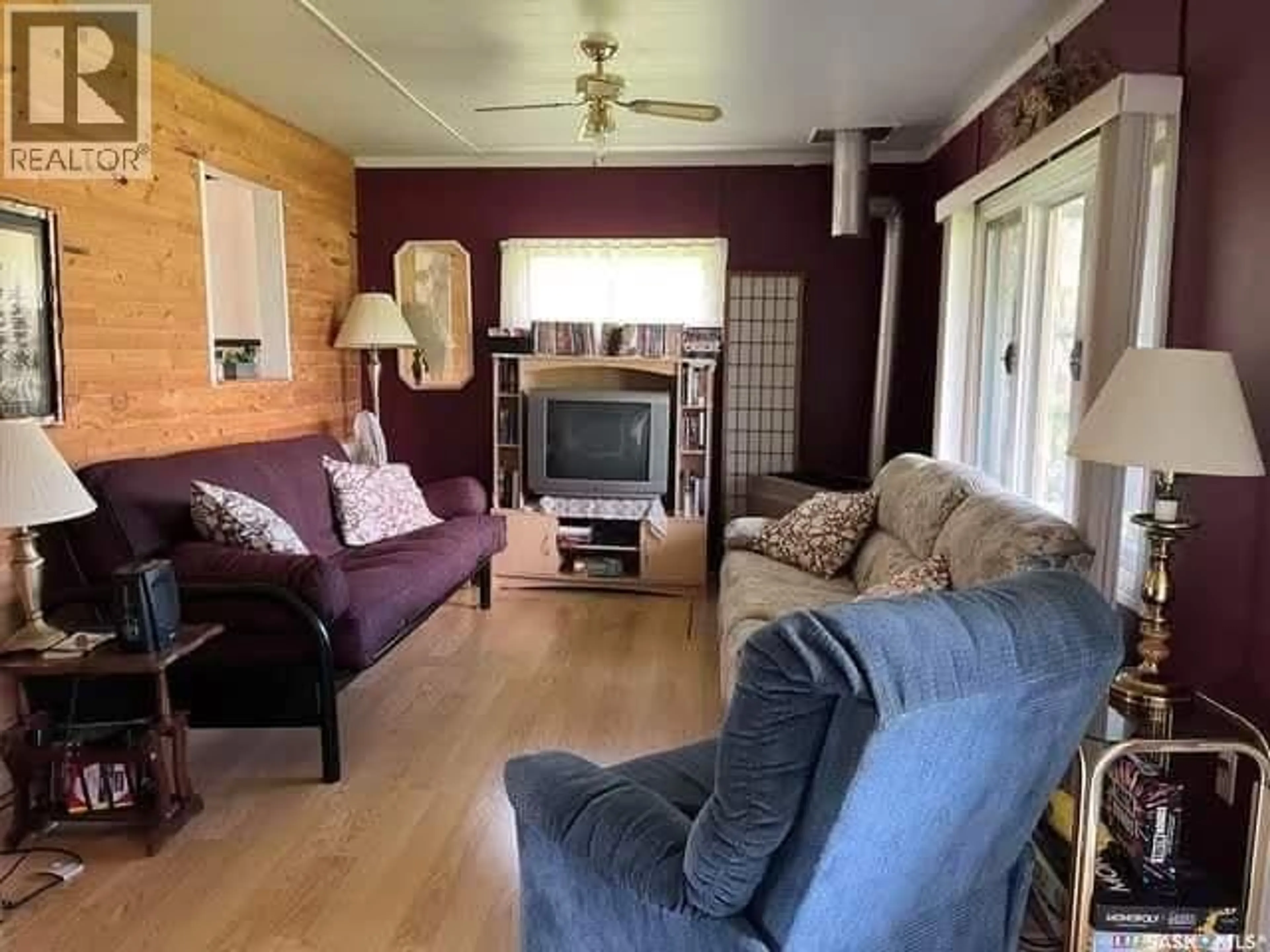 Living room with furniture, wood/laminate floor for 113 FOSTER STREET, Lakeland Rm No. 521 Saskatchewan S0J0N0
