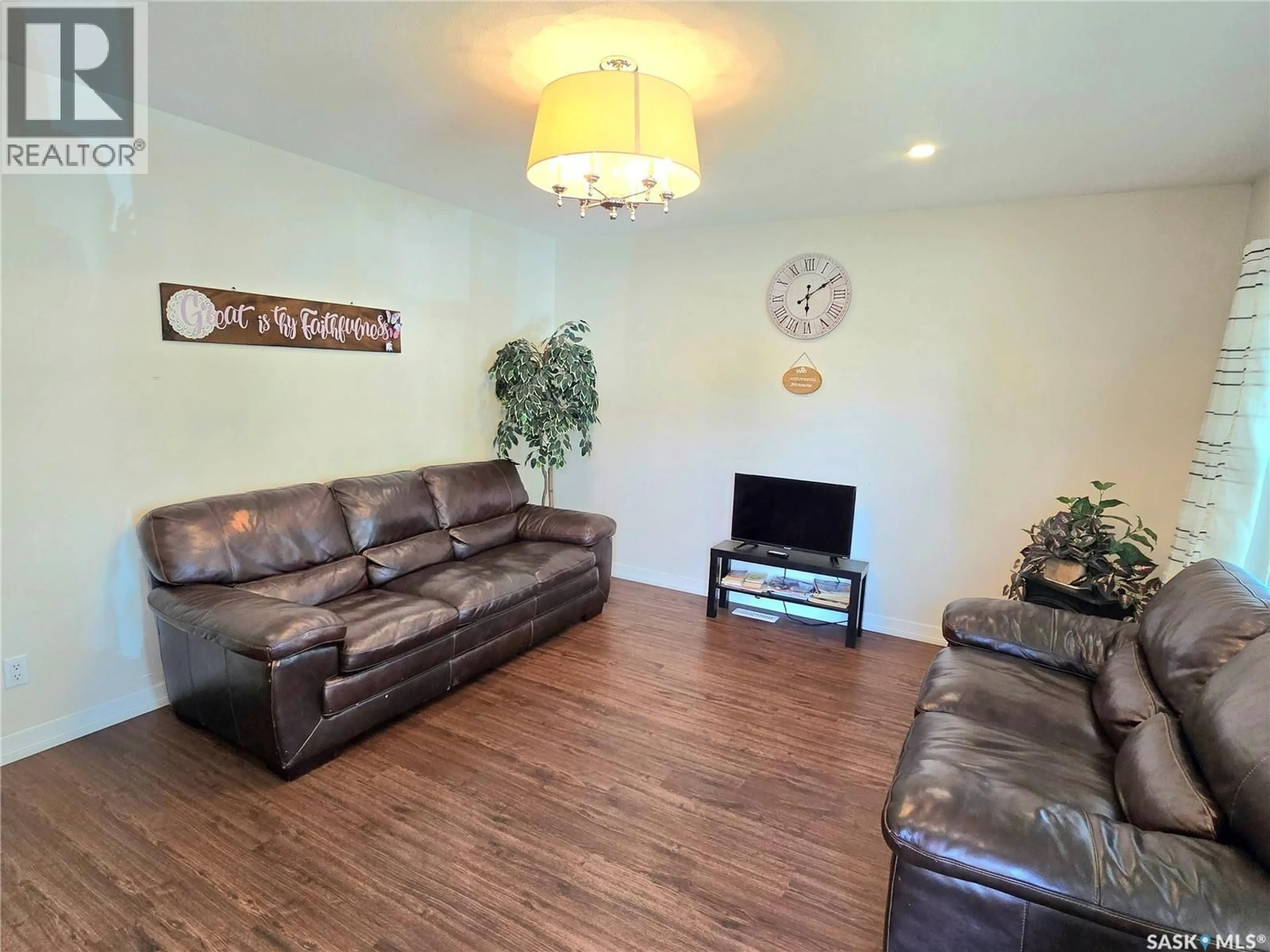 Living room with furniture, wood/laminate floor for 1811 20TH STREET, Saskatoon Saskatchewan S7M1A1