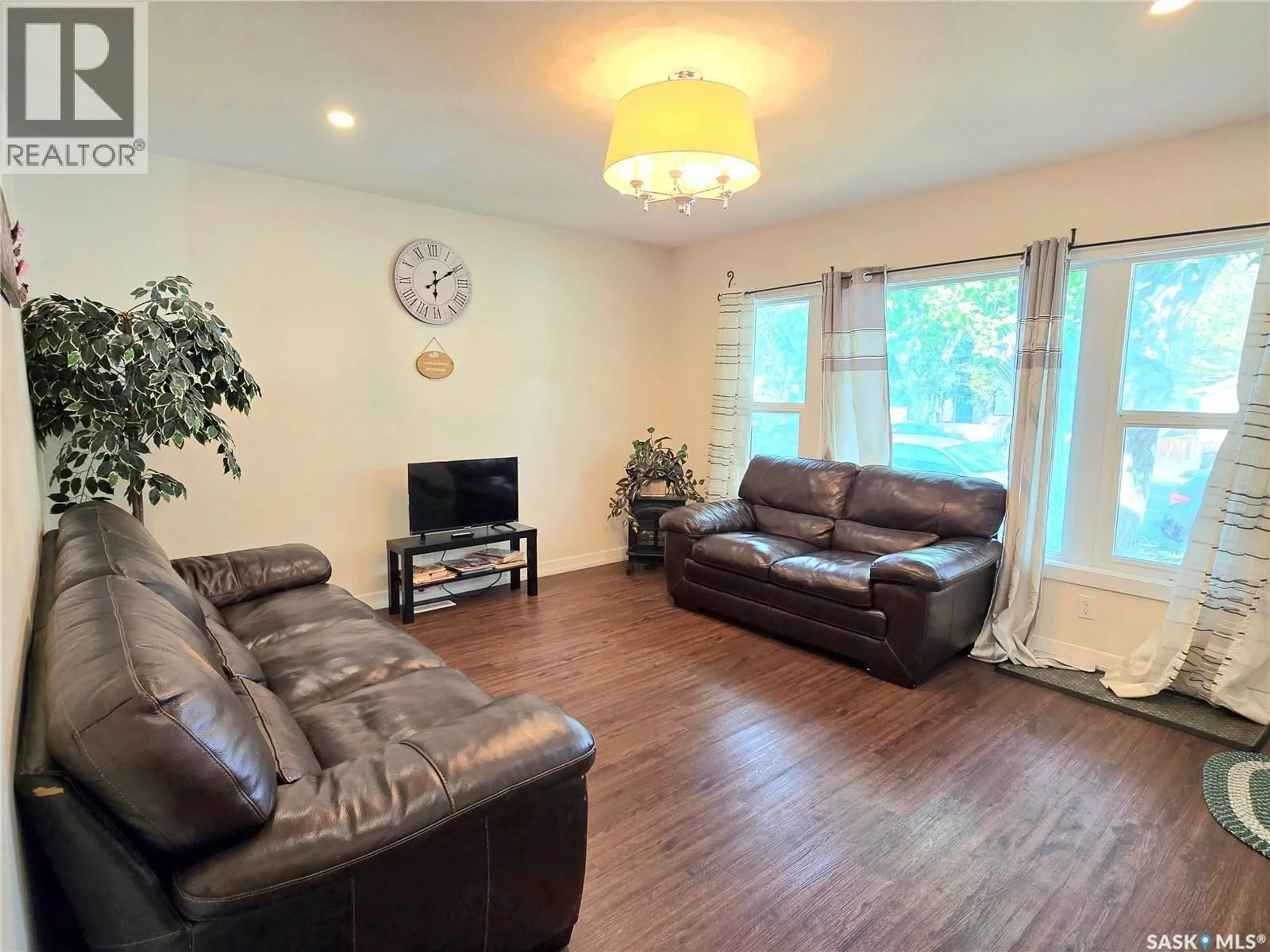 Living room with furniture, wood/laminate floor for 1811 20TH STREET, Saskatoon Saskatchewan S7M1A1