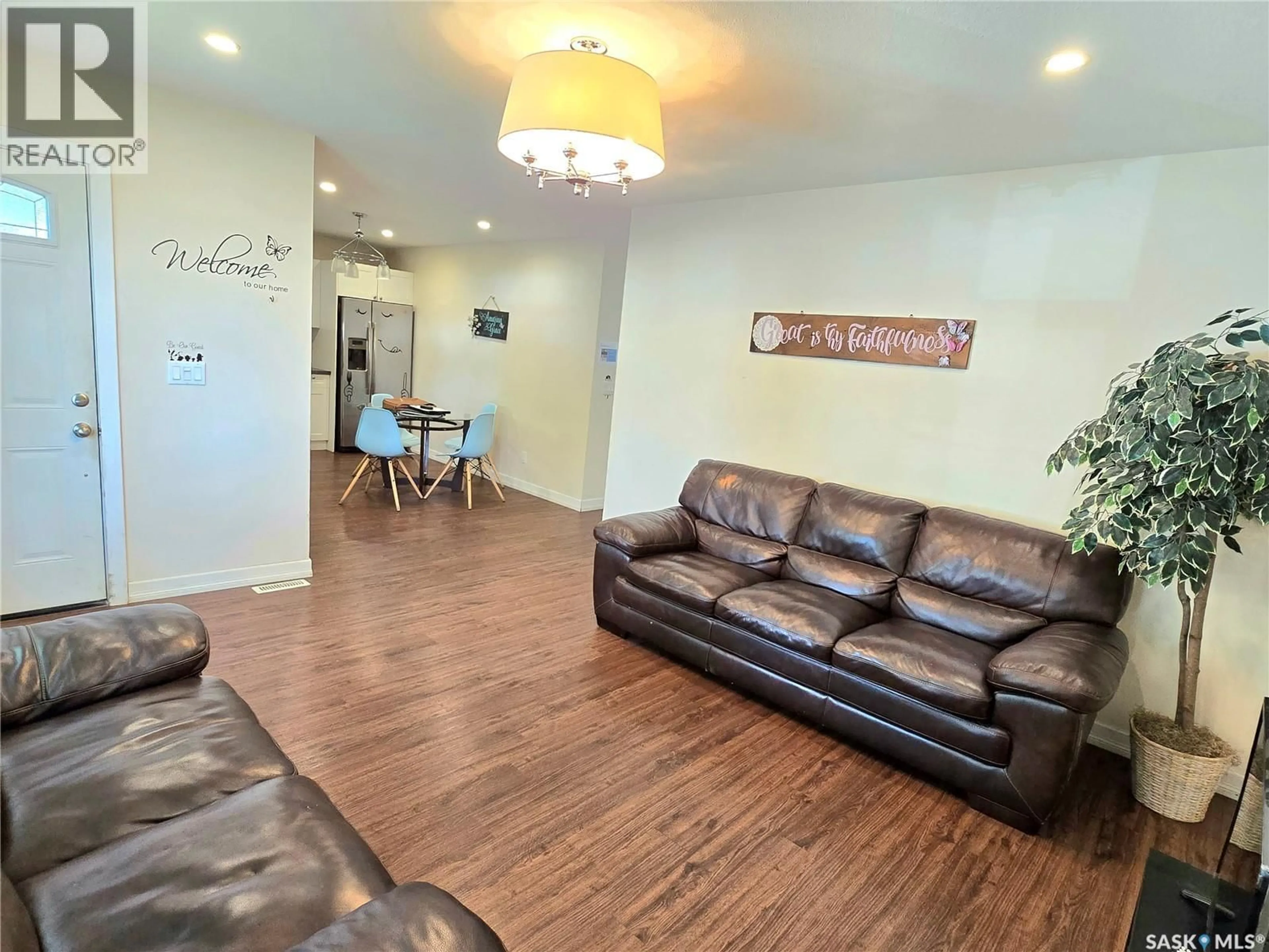 Living room with furniture, wood/laminate floor for 1811 20TH STREET, Saskatoon Saskatchewan S7M1A1