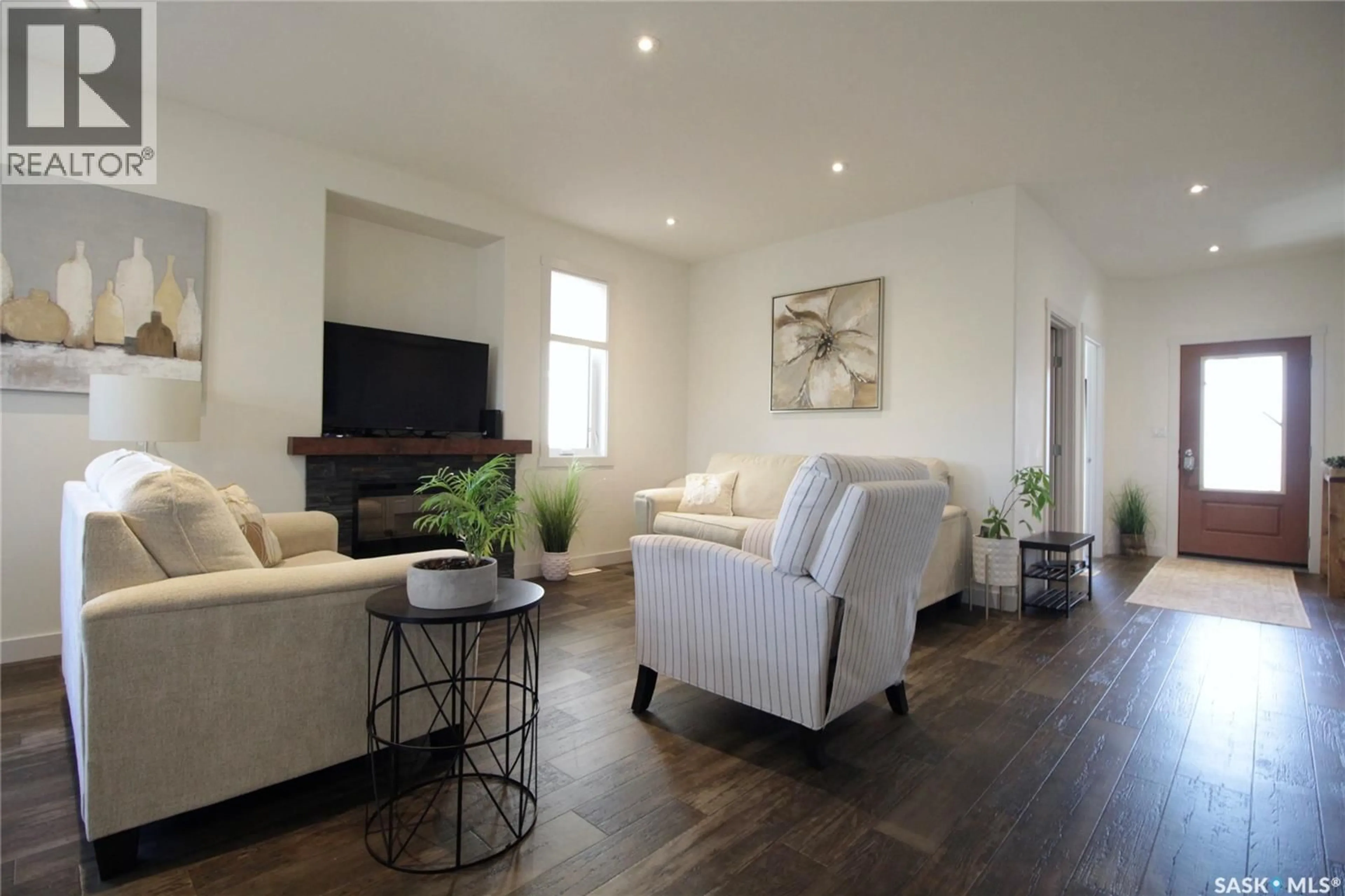 Living room with furniture, wood/laminate floor for 115A DORCHESTER PLACE, Moosomin Saskatchewan S0G3N0