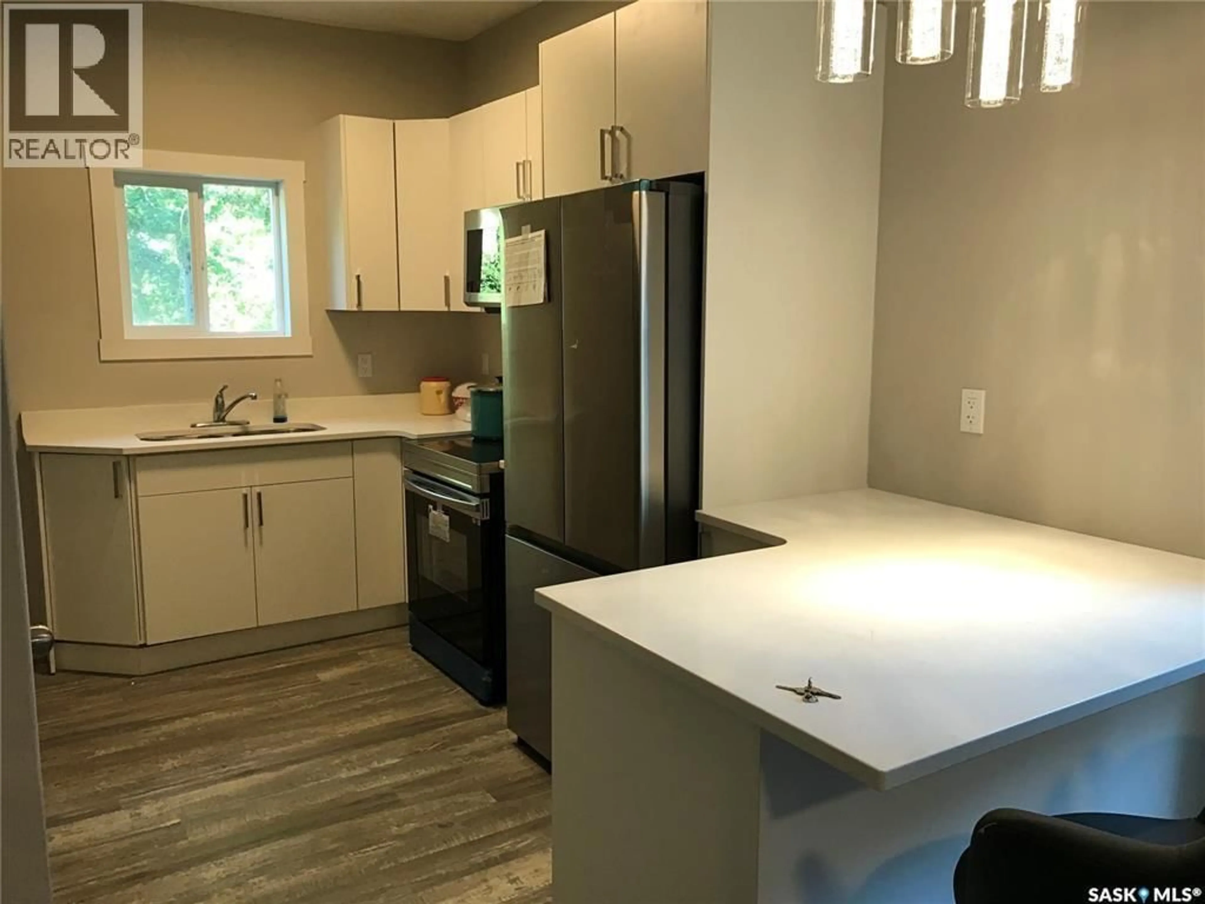 Open concept kitchen, wood/laminate floor for 1143 MONTAGUE STREET, Regina Saskatchewan S4T3H8