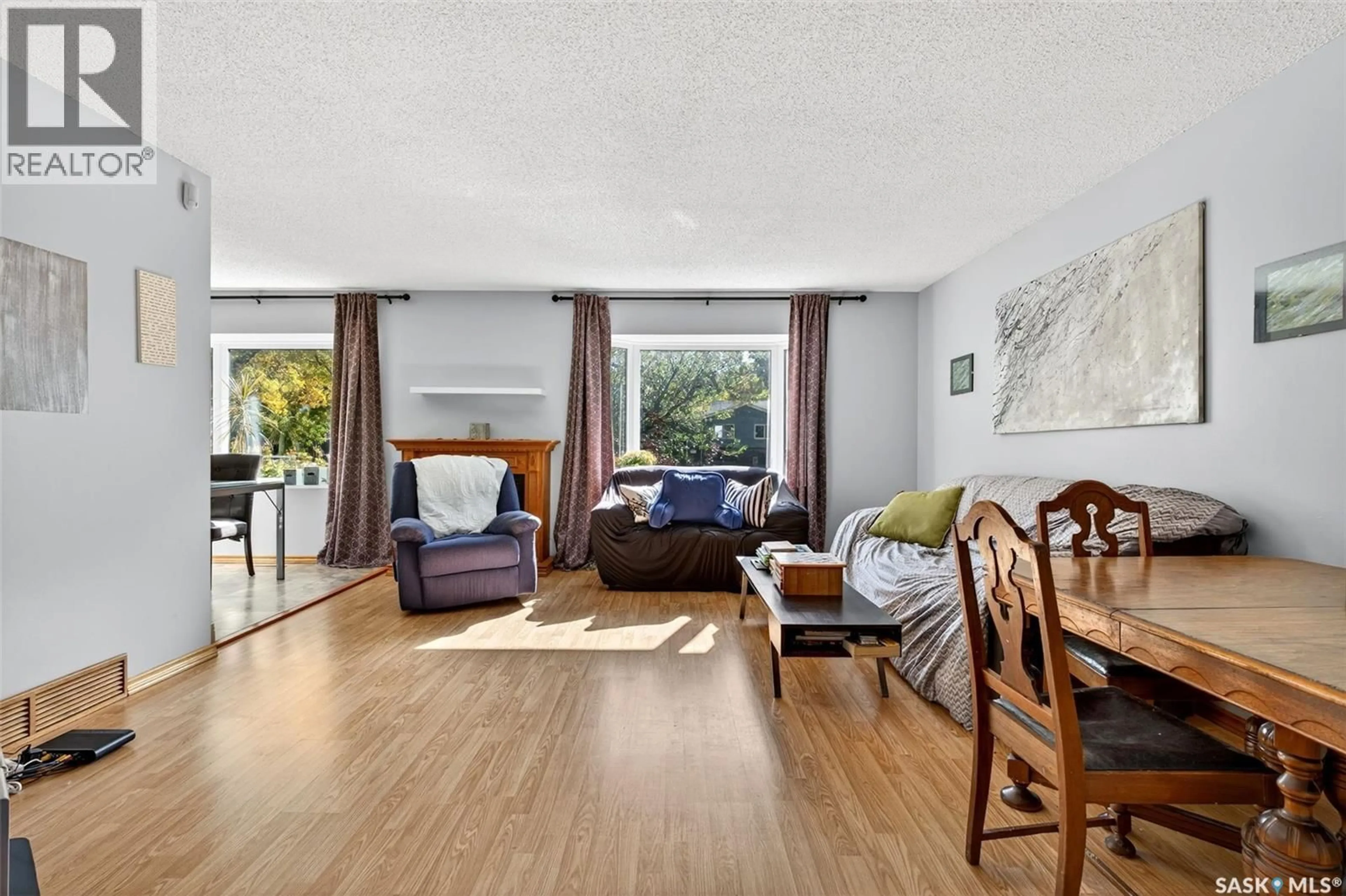Living room with furniture, wood/laminate floor for 210 CHURCH DRIVE, Regina Saskatchewan S4X1M1