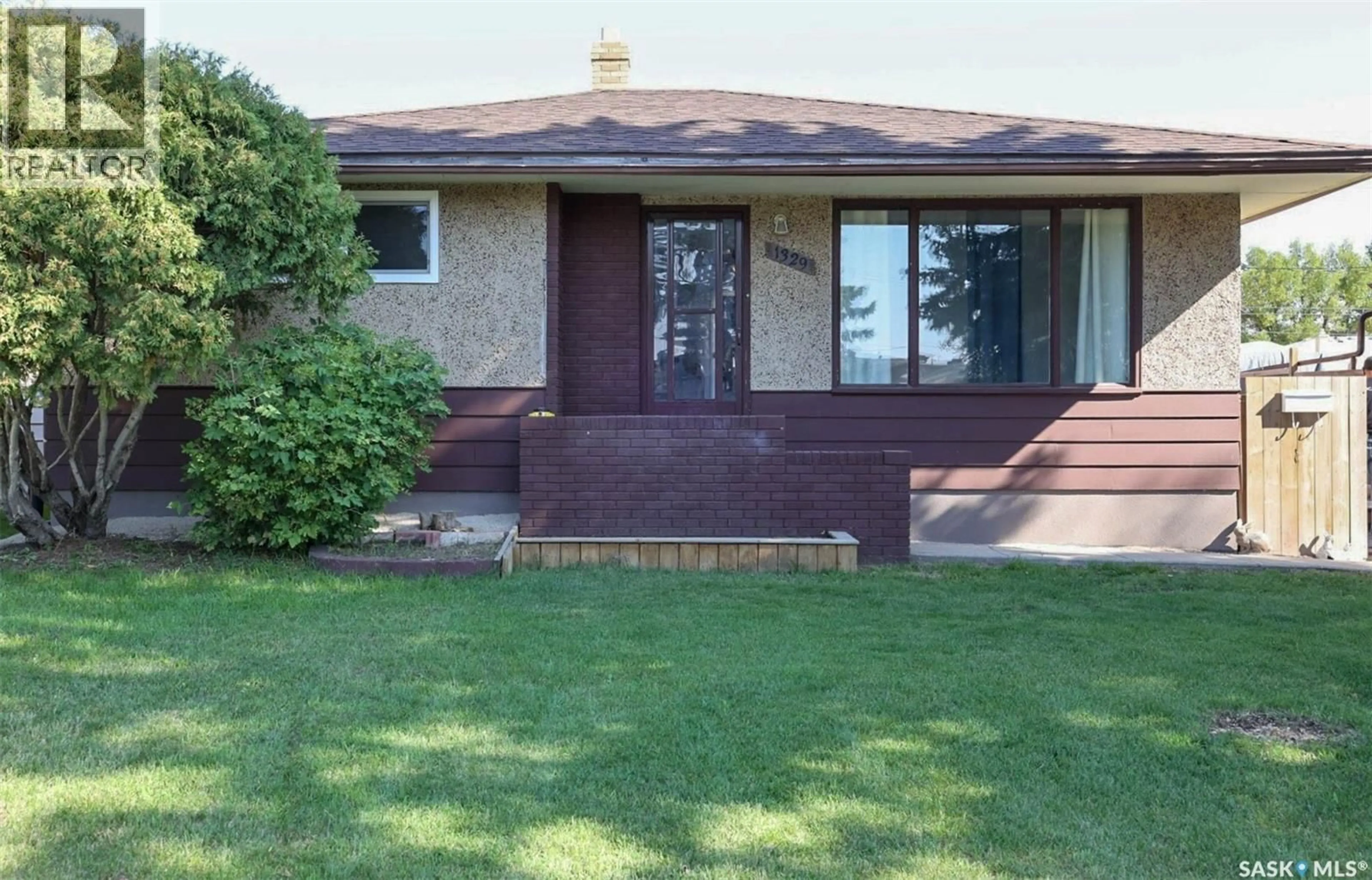 Home with brick exterior material, street for 1329 ROTHWELL STREET, Regina Saskatchewan S4R0K6
