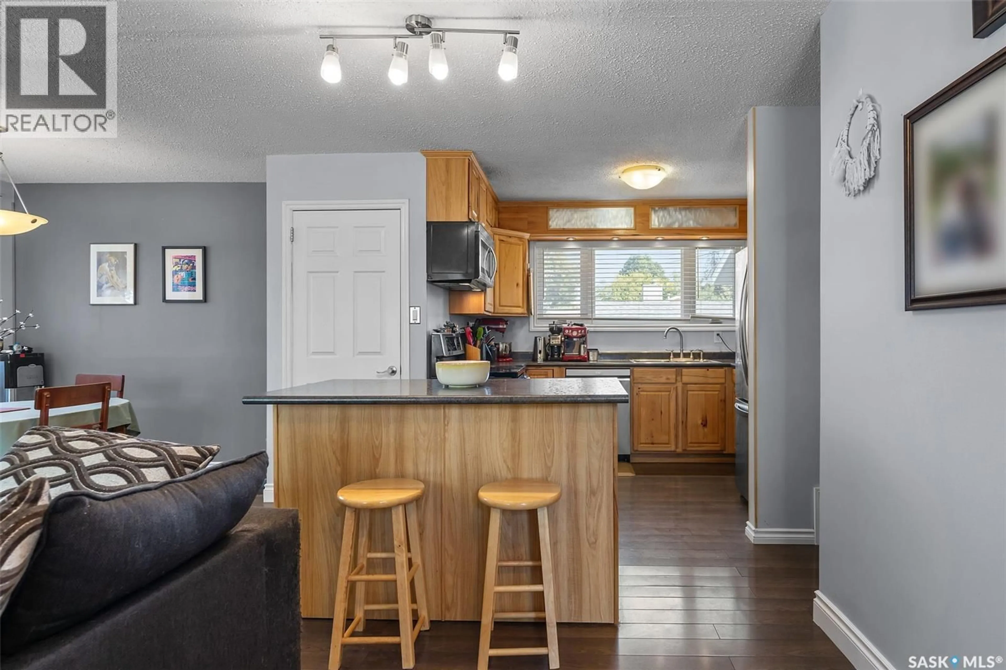 Open concept kitchen, wood/laminate floor for 342 VANCOUVER AVENUE, Saskatoon Saskatchewan S7L3P6